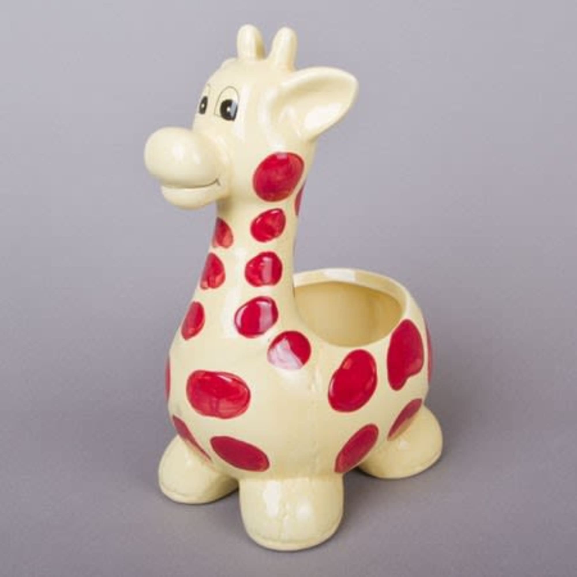 Ceramic giraffe-shaped planter with red spots
