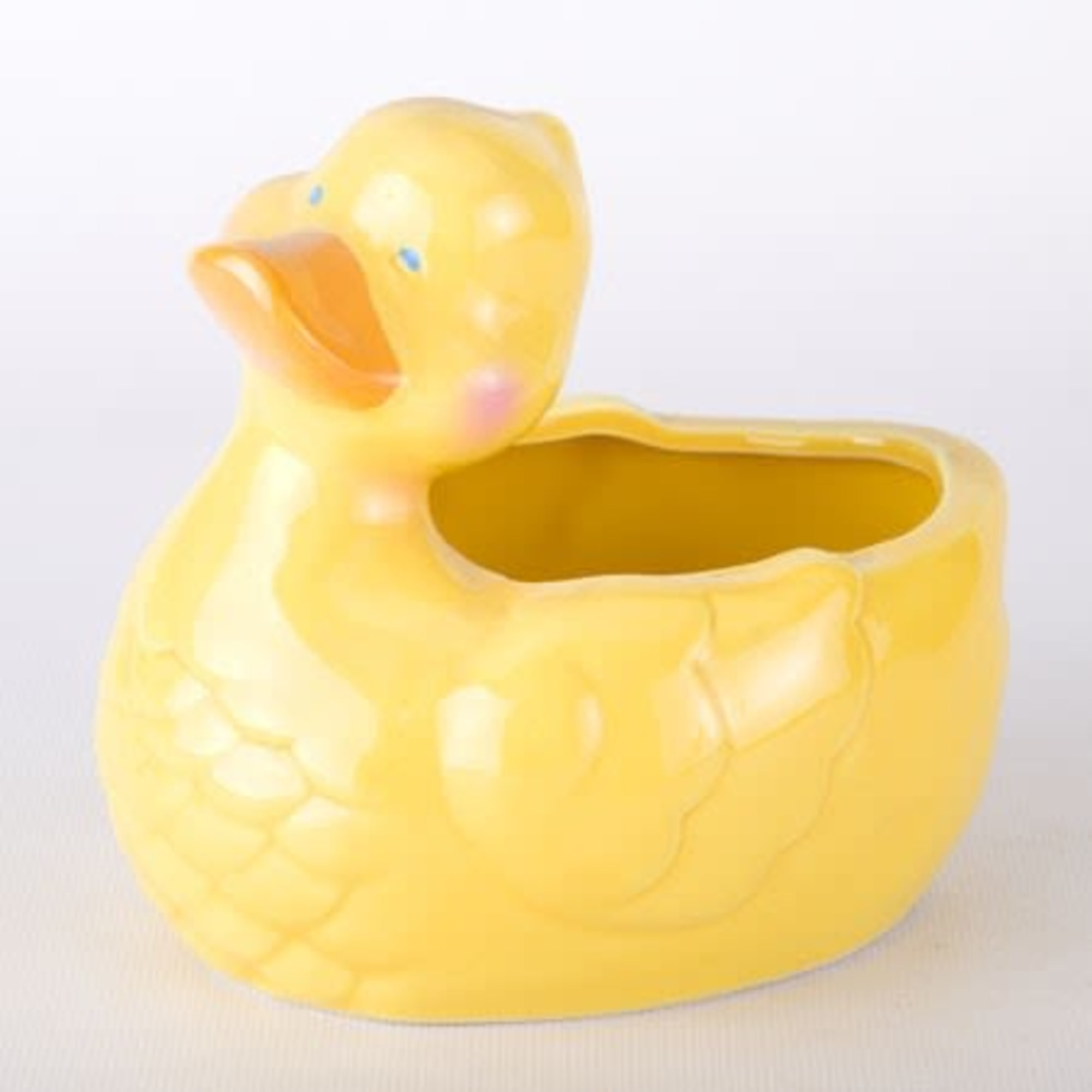 Yellow duck-shaped ceramic planter with an open top