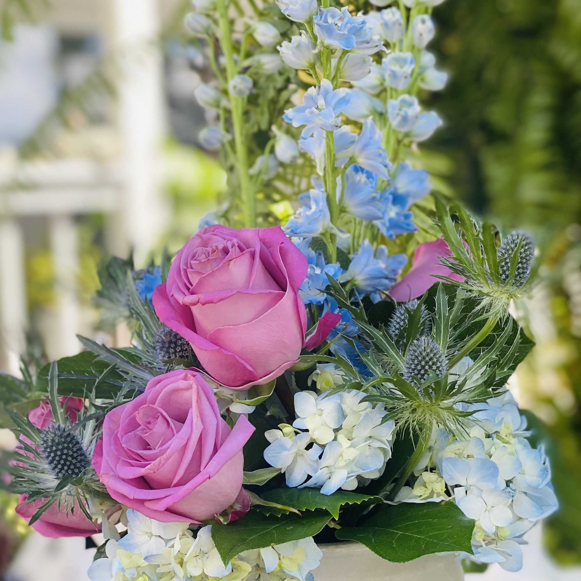White compote (pedestal bowl) filled seasonal flowers like Delphinium or stock, hydrangea, photo 2 of 2