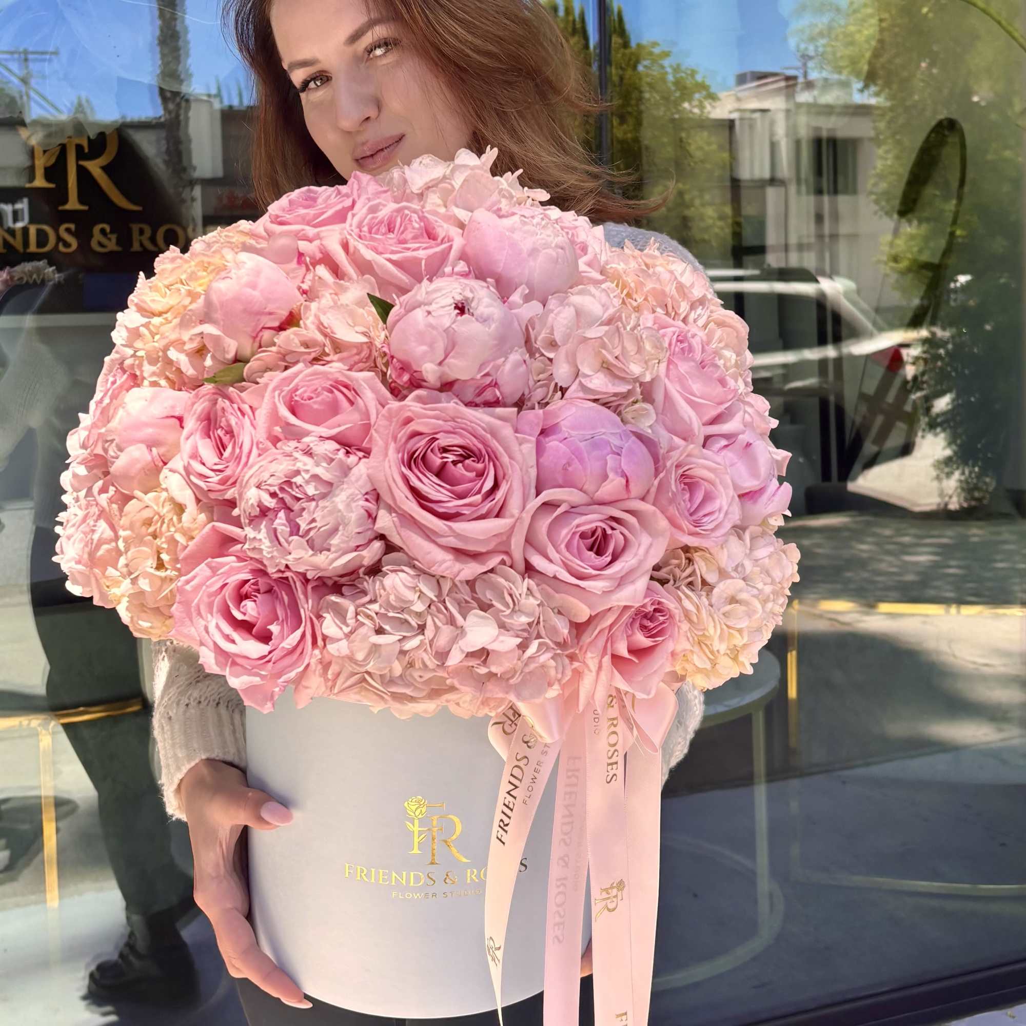 A beautiful arrangement of blush garden roses, peonies, and hydrangeas, artfully designed, photo 2 of 3