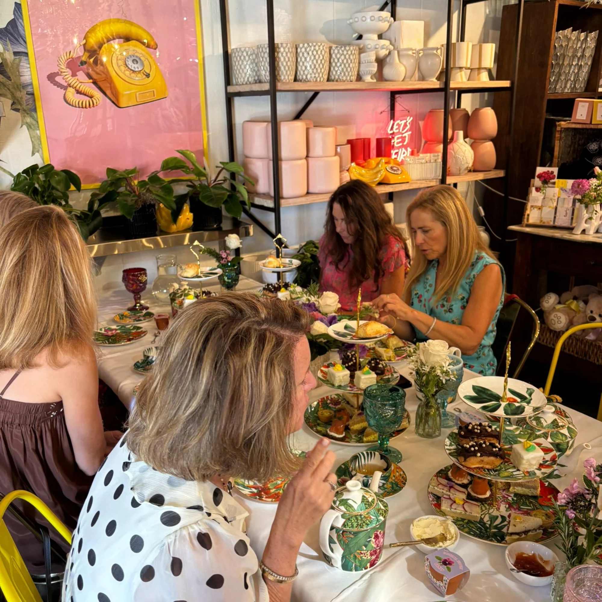 Table setting with floral plates and small flower arrangements at a gathering