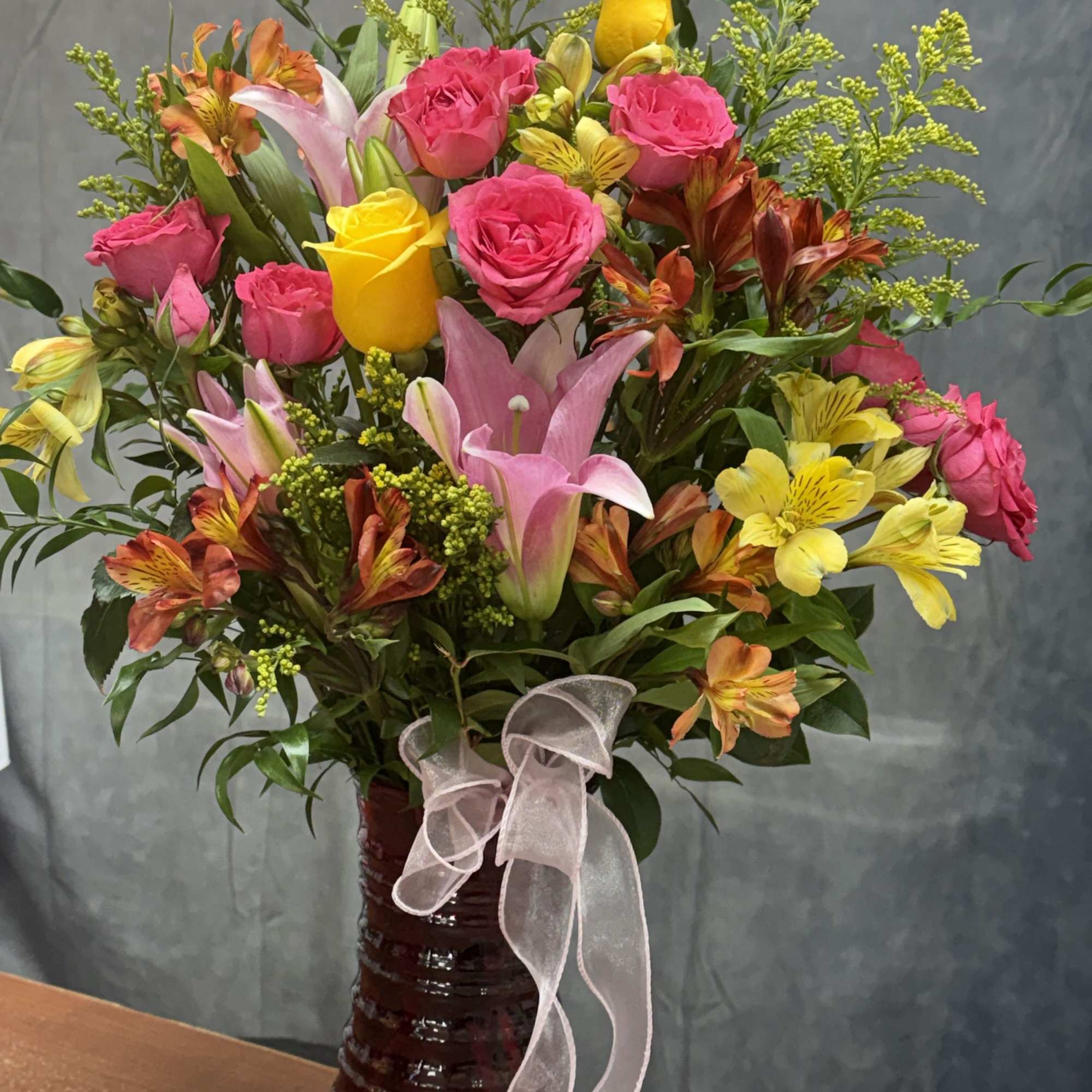 A bright and cheerful small vase featuring warm orange lilies, lively orange, photo 2 of 2