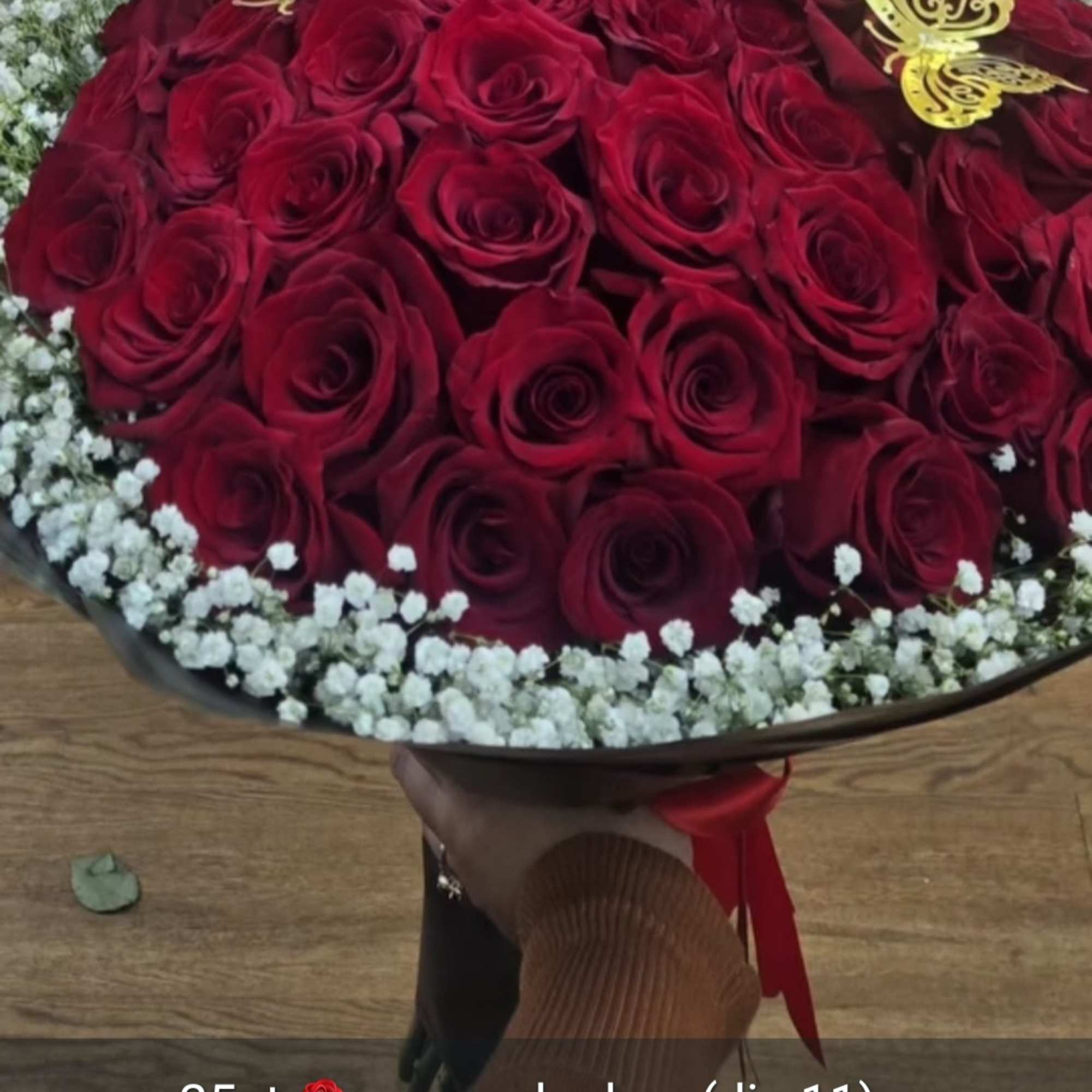 Bouquet of red roses with white baby's breath and gold butterfly picks