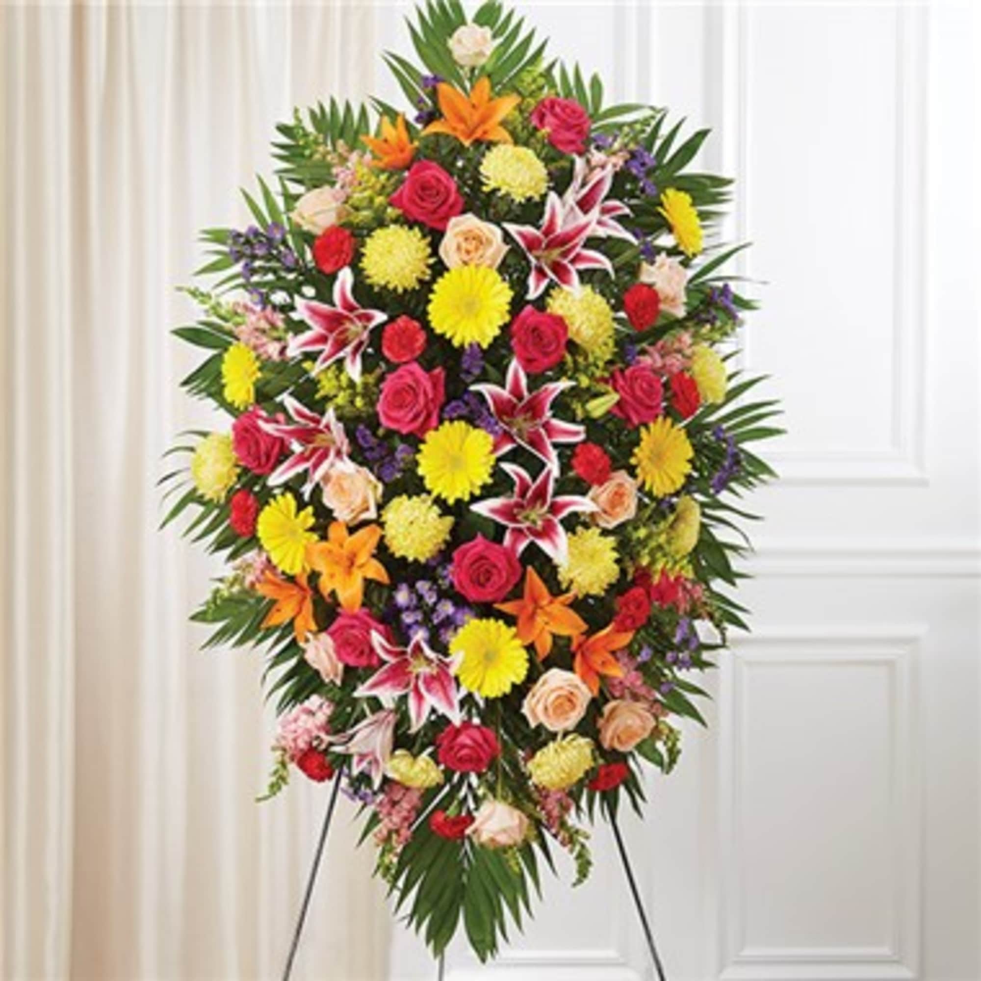 Large standing spray of mixed flowers on an easel