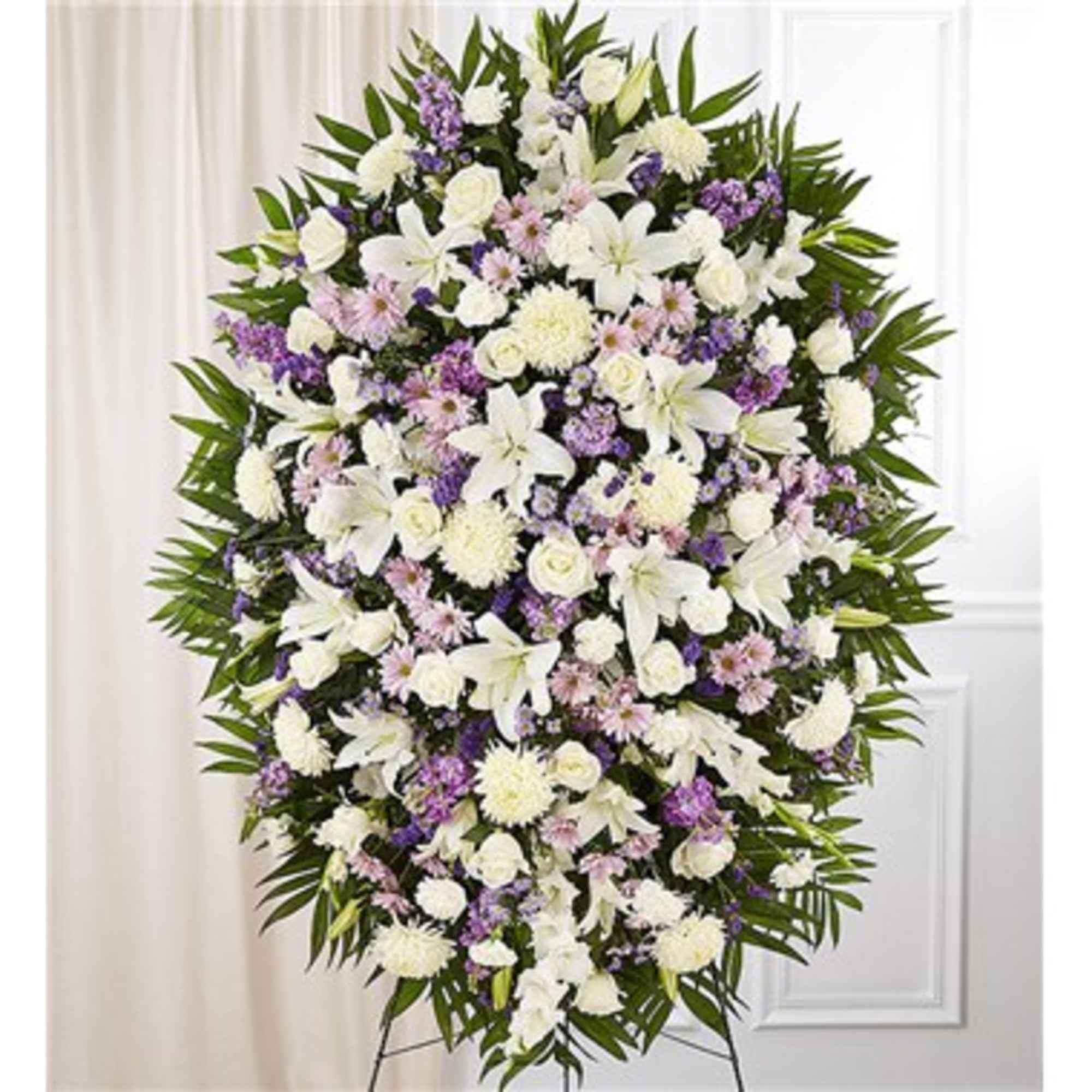 Large standing spray of white and lavender flowers on an easel