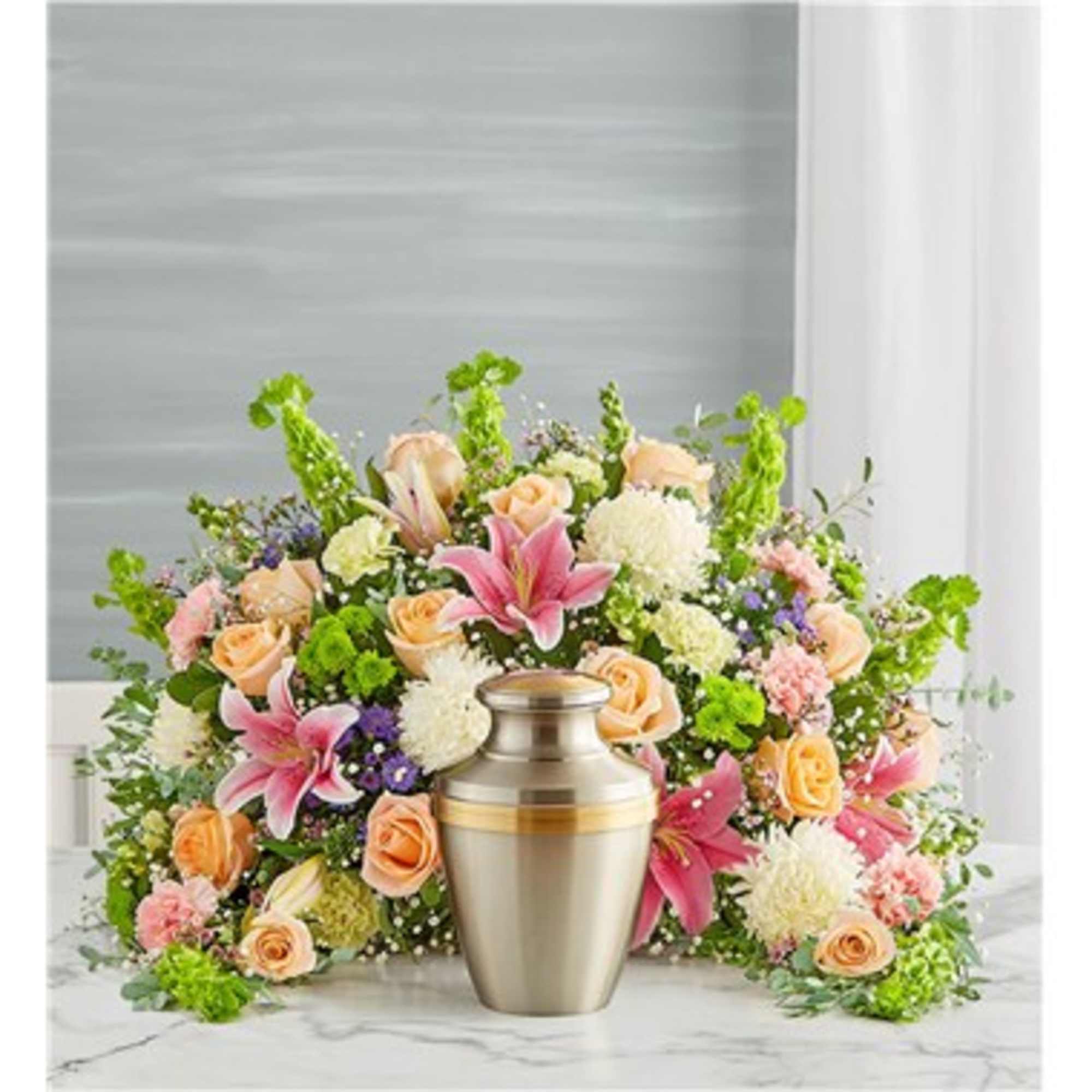 Pastel floral arrangement with a metal urn centerpiece