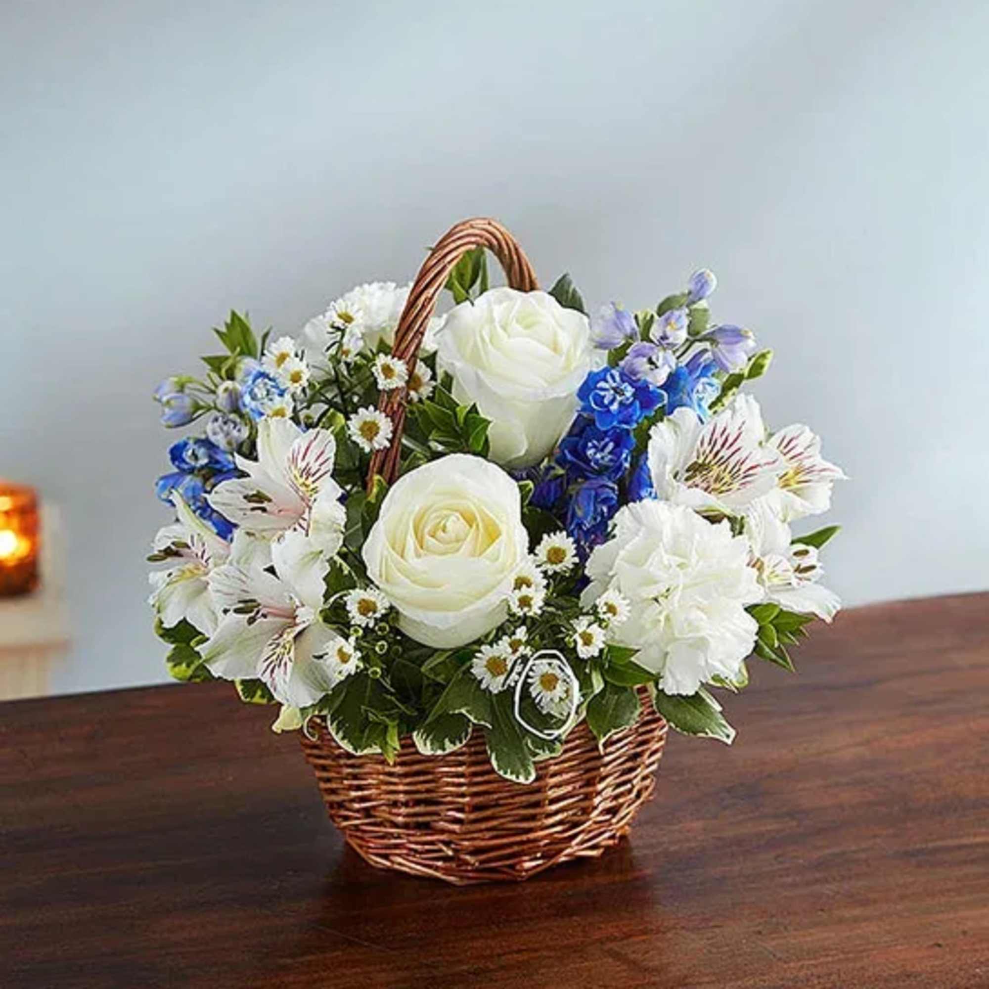 White and blue flower basket in a wicker basket