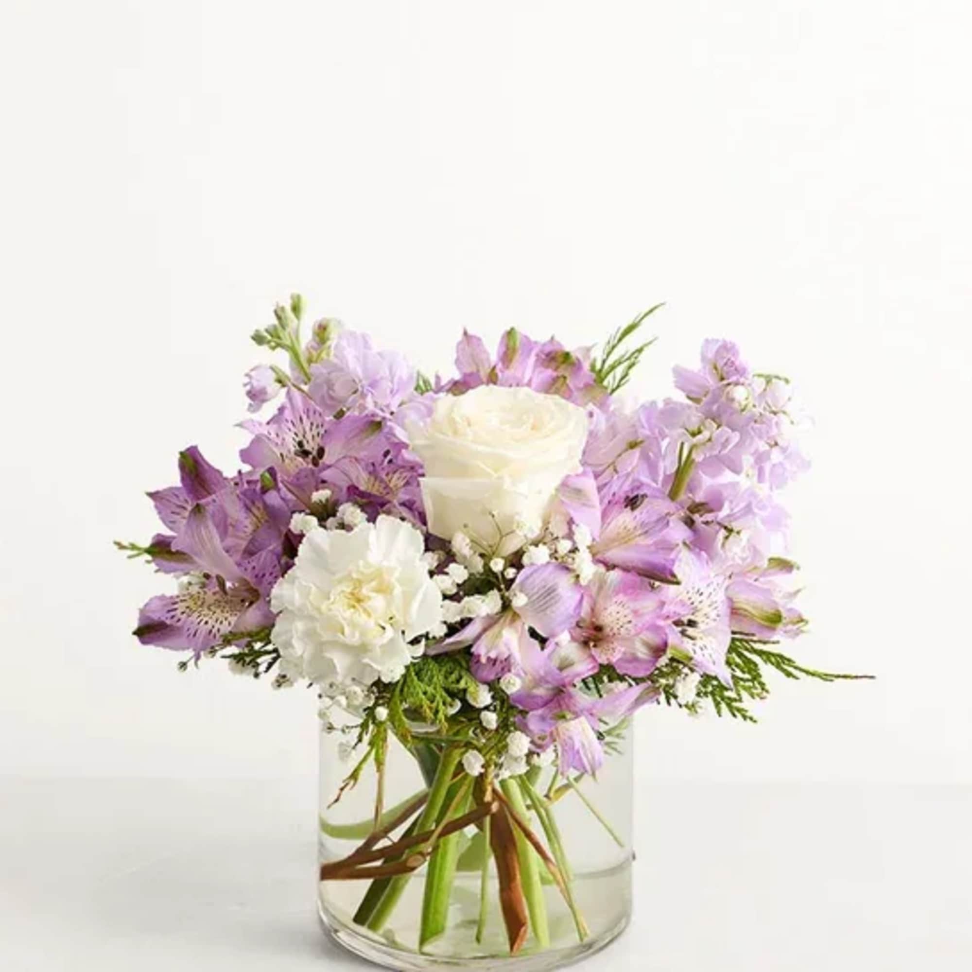 Lavender and white bouquet in a clear glass vase