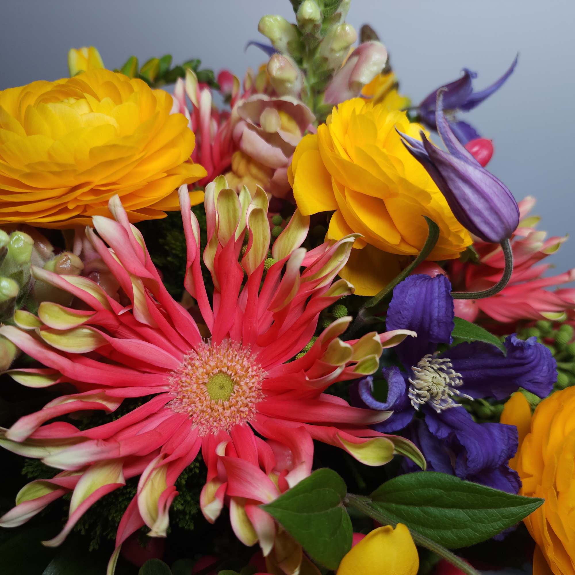 Bright mixed bouquet with yellow, pink, and purple flowers