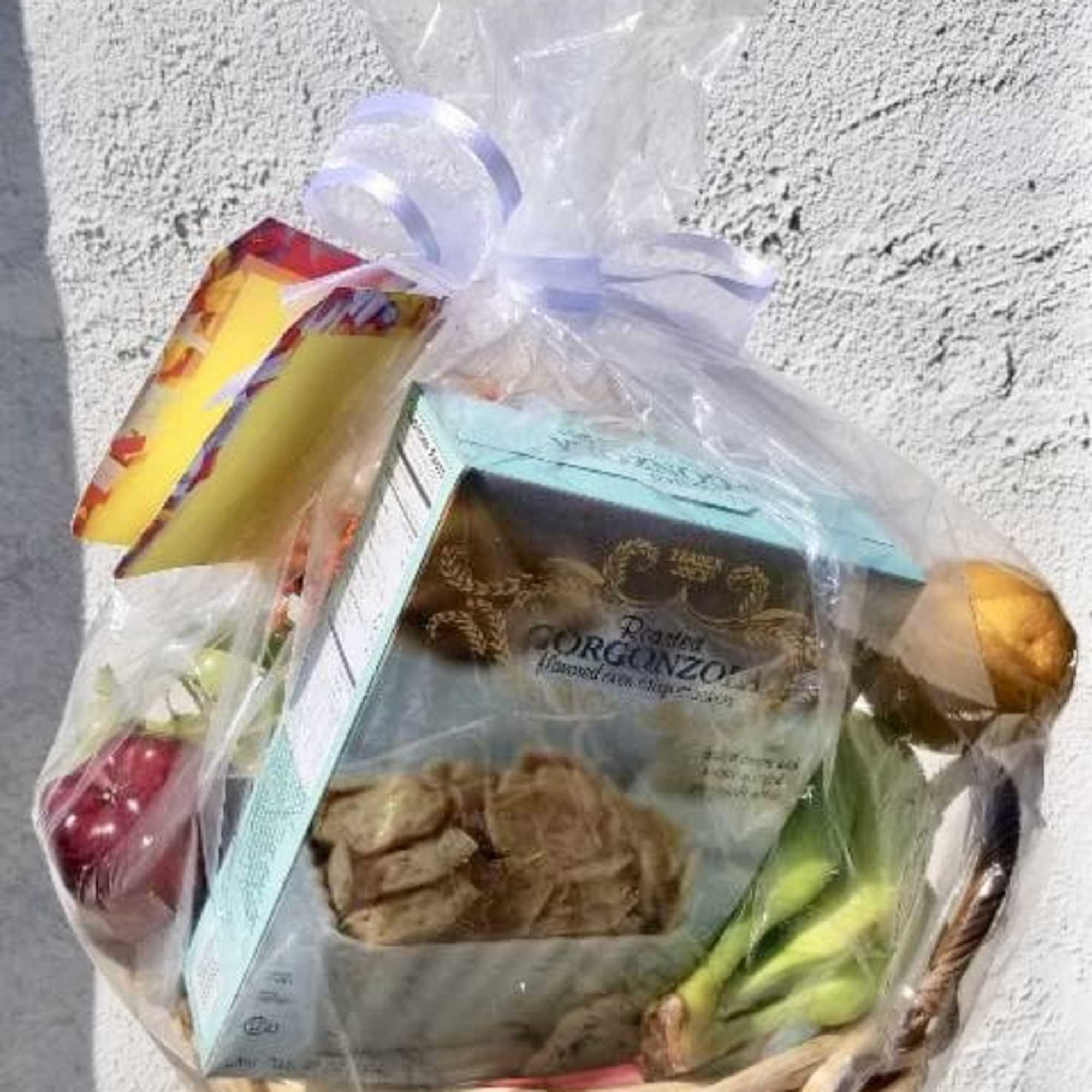 Gift basket with packaged snacks and a ribbon