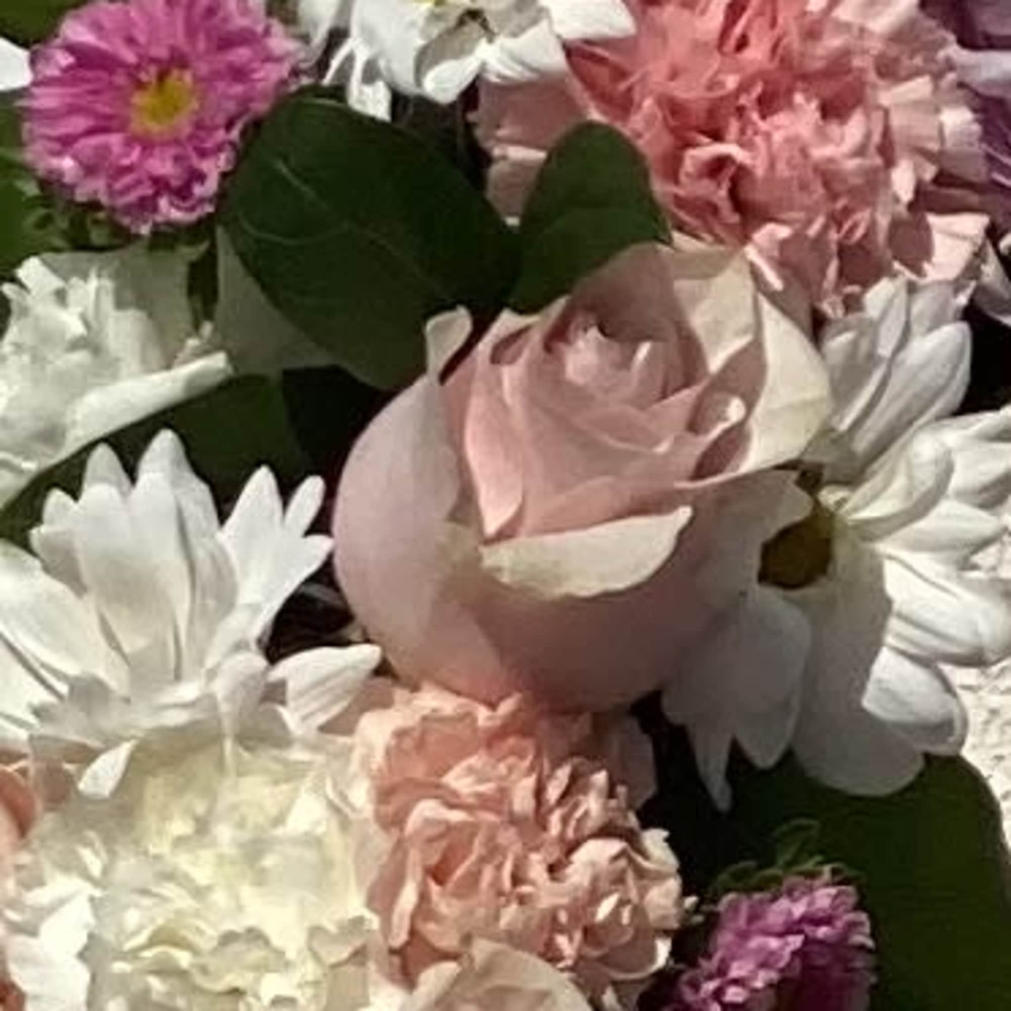Bouquet of pink and white flowers with green leaves