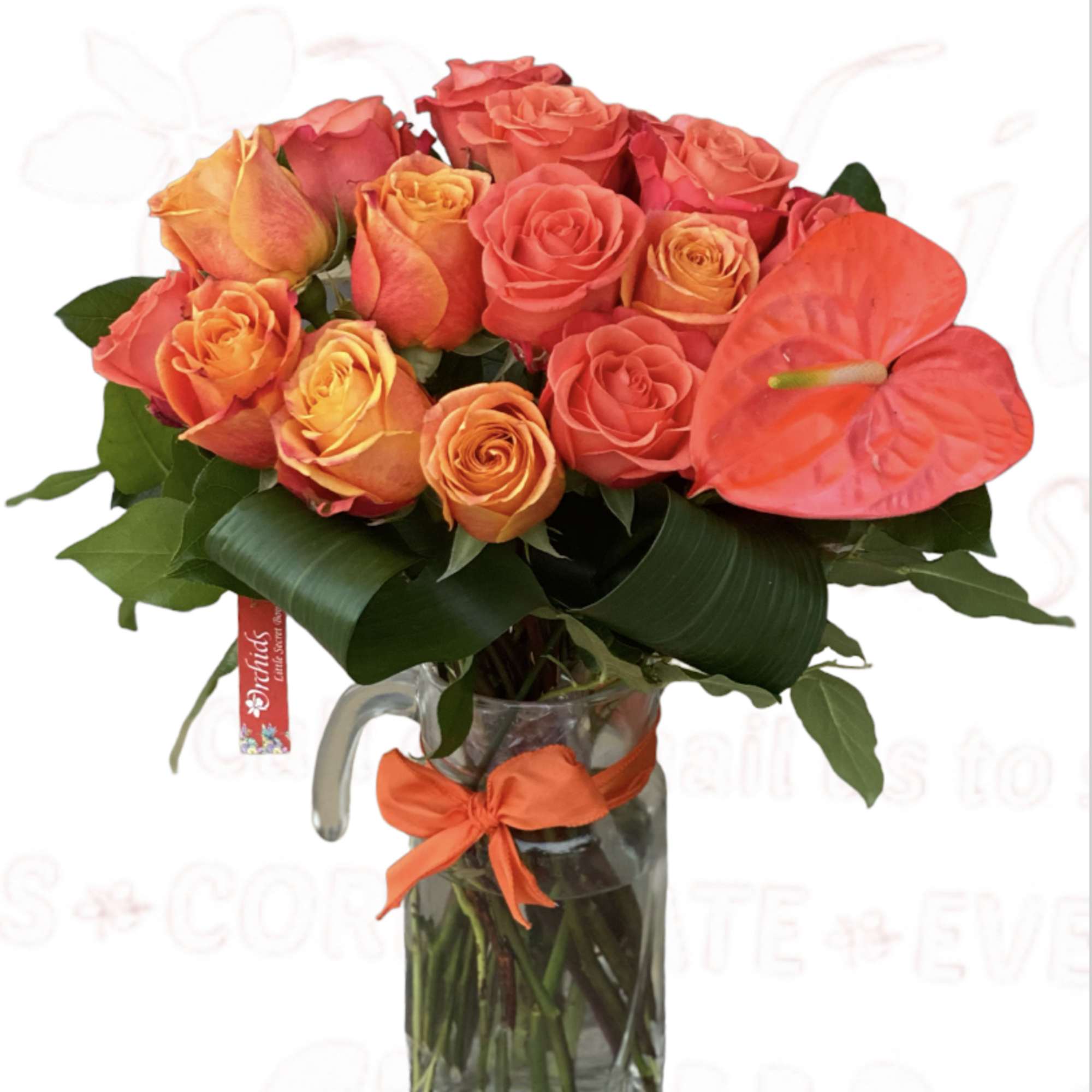 Bouquet of orange and coral roses in a glass pitcher vase