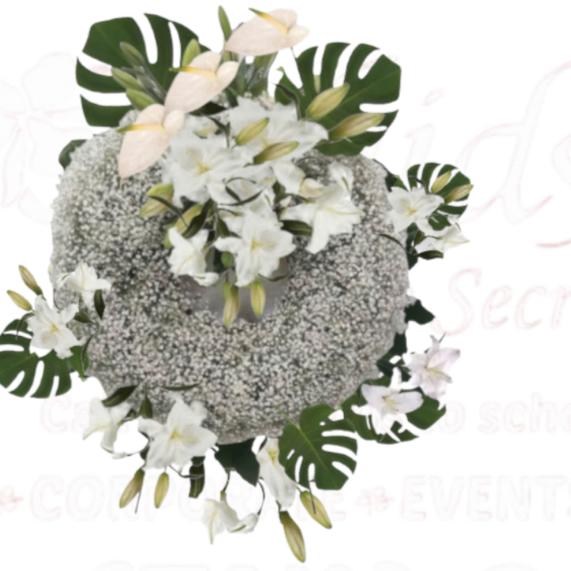 White floral arrangement with lilies and tropical leaves