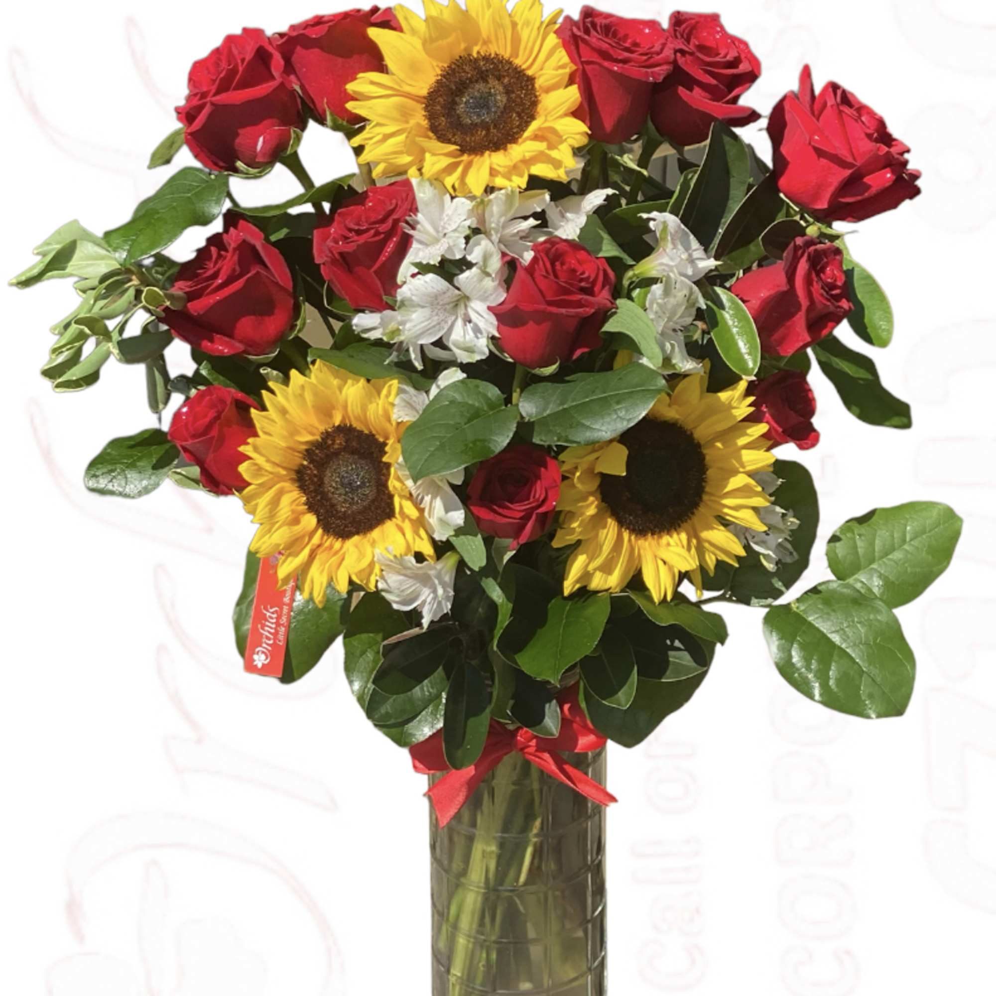 Bouquet of red roses and yellow sunflowers in a glass vase