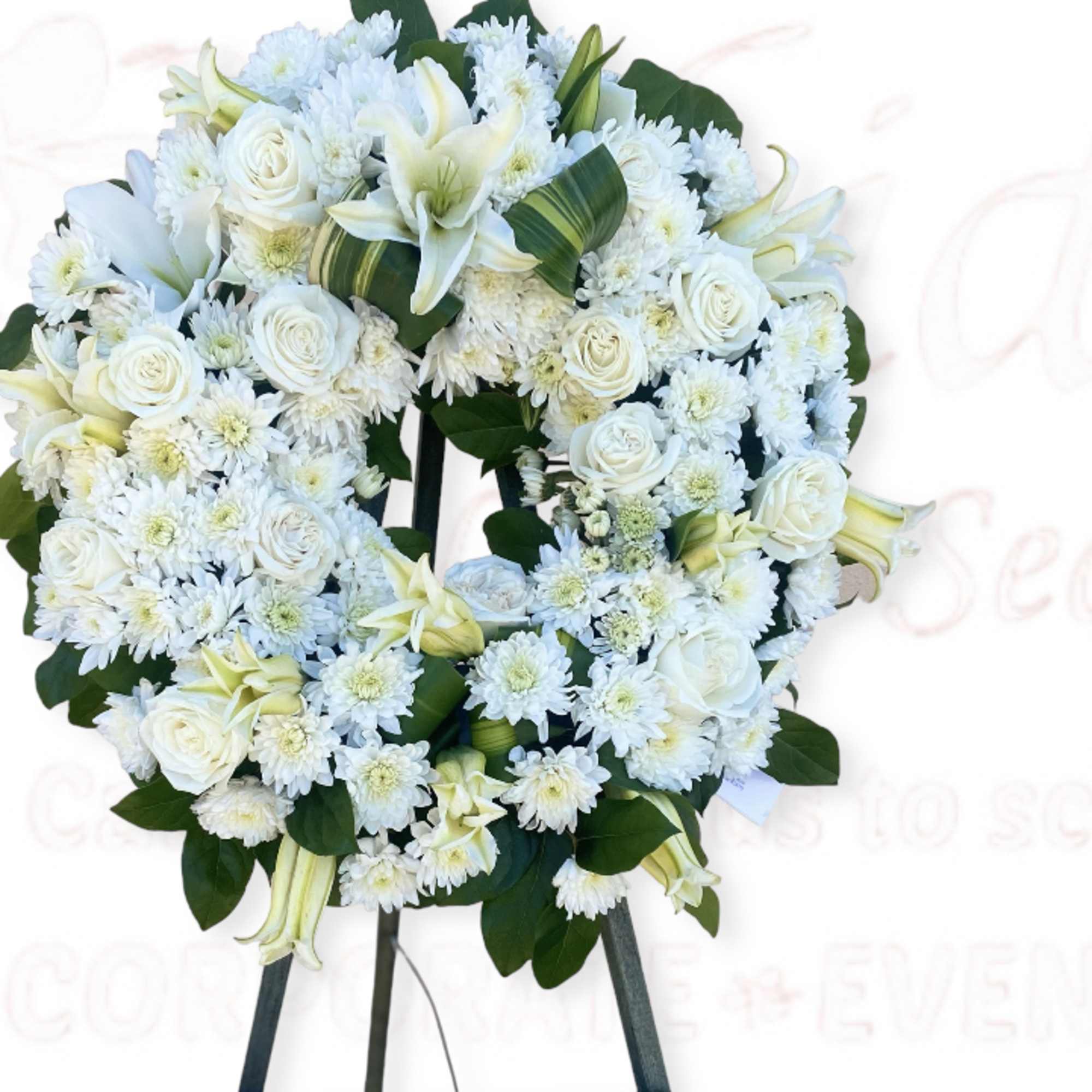 White floral wreath on a standing easel