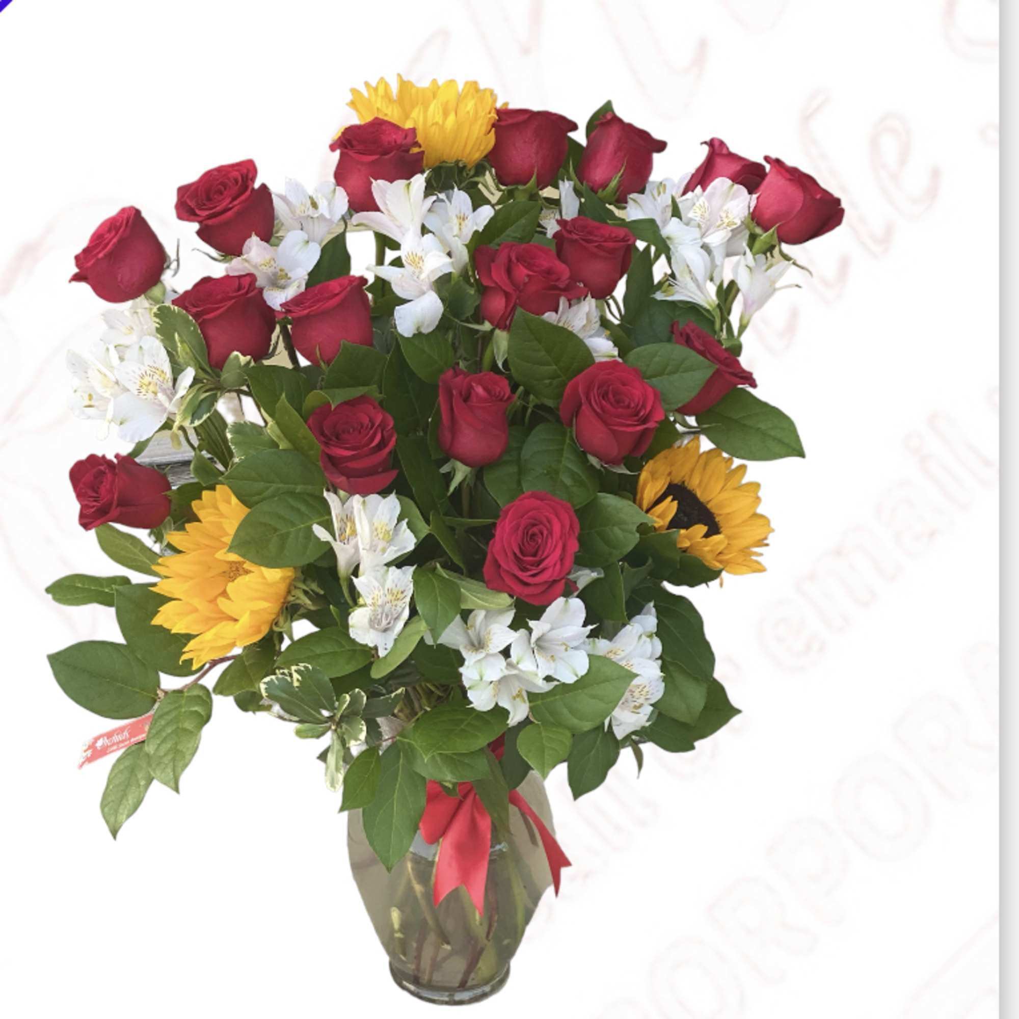 Bouquet of red roses, white alstroemeria, and yellow sunflowers in a glass vase