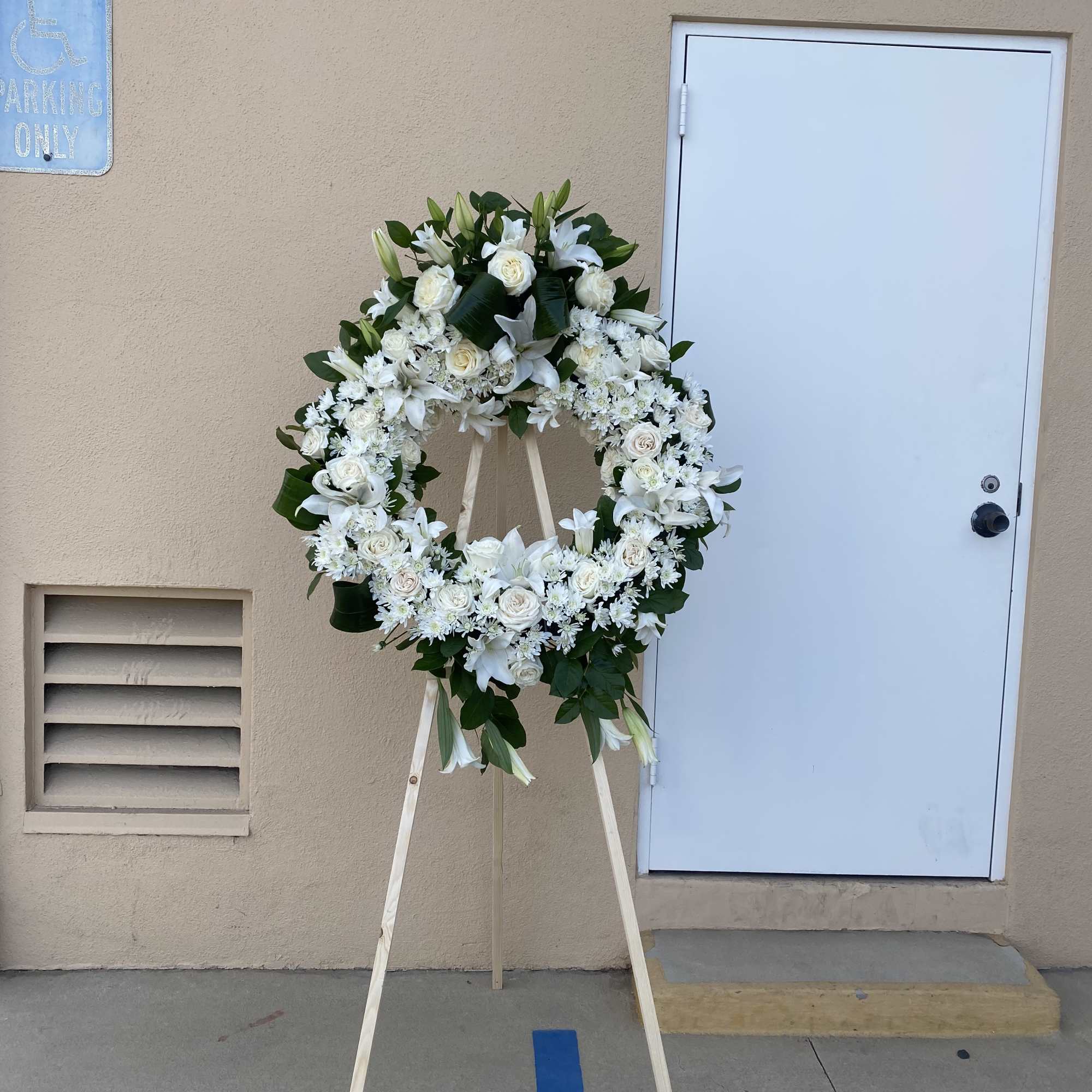 White floral wreath on a standing easel