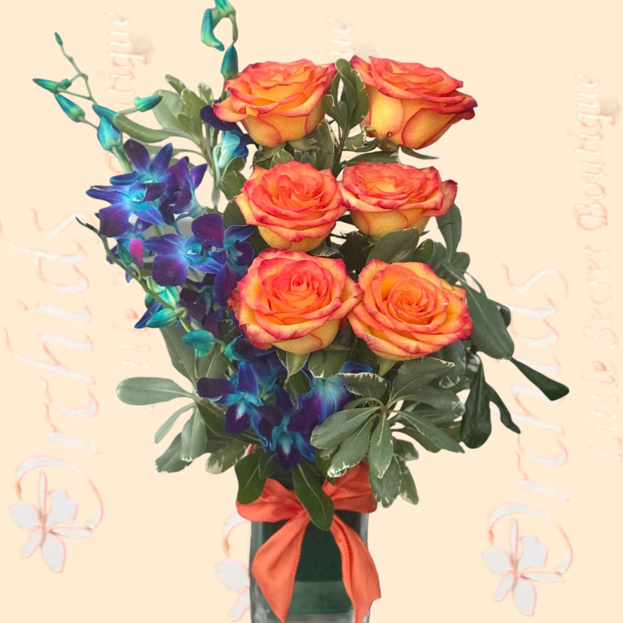 Bouquet of orange roses and blue orchids in a glass vase