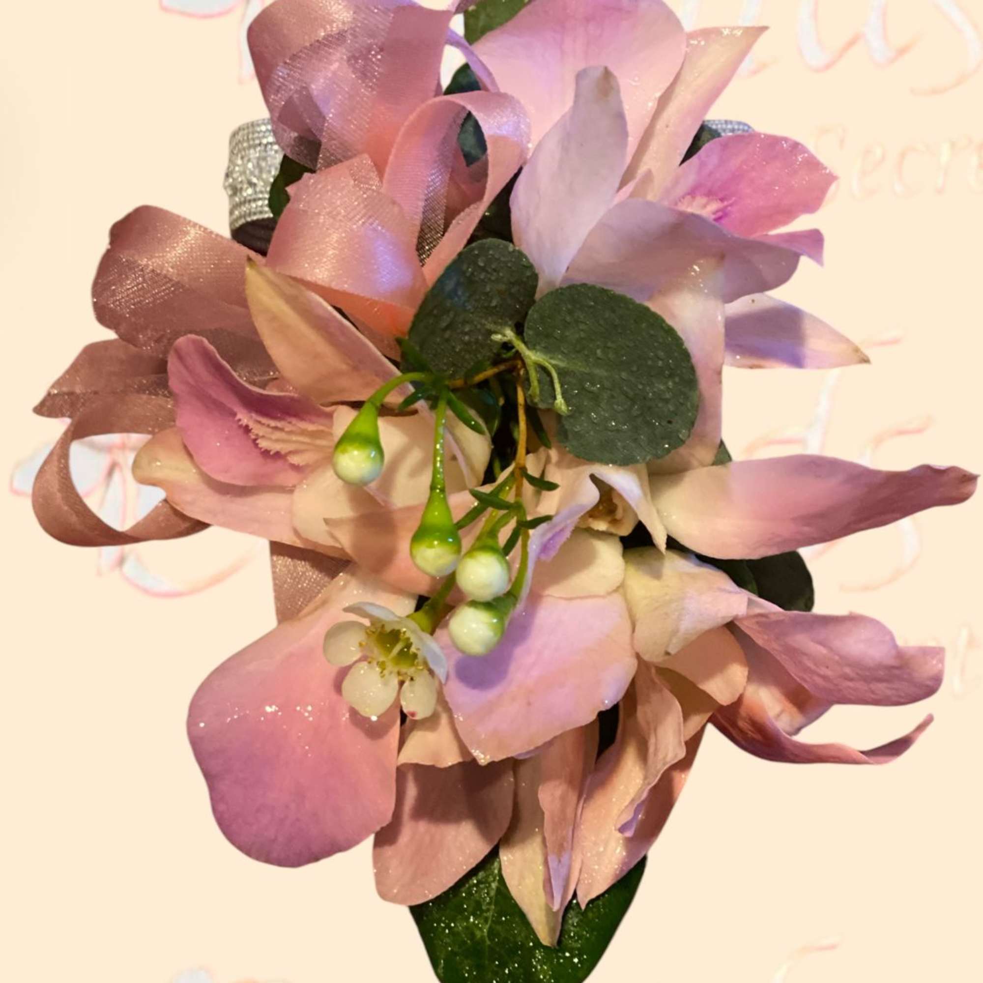 Pink and lavender orchid corsage with ribbon and berries
