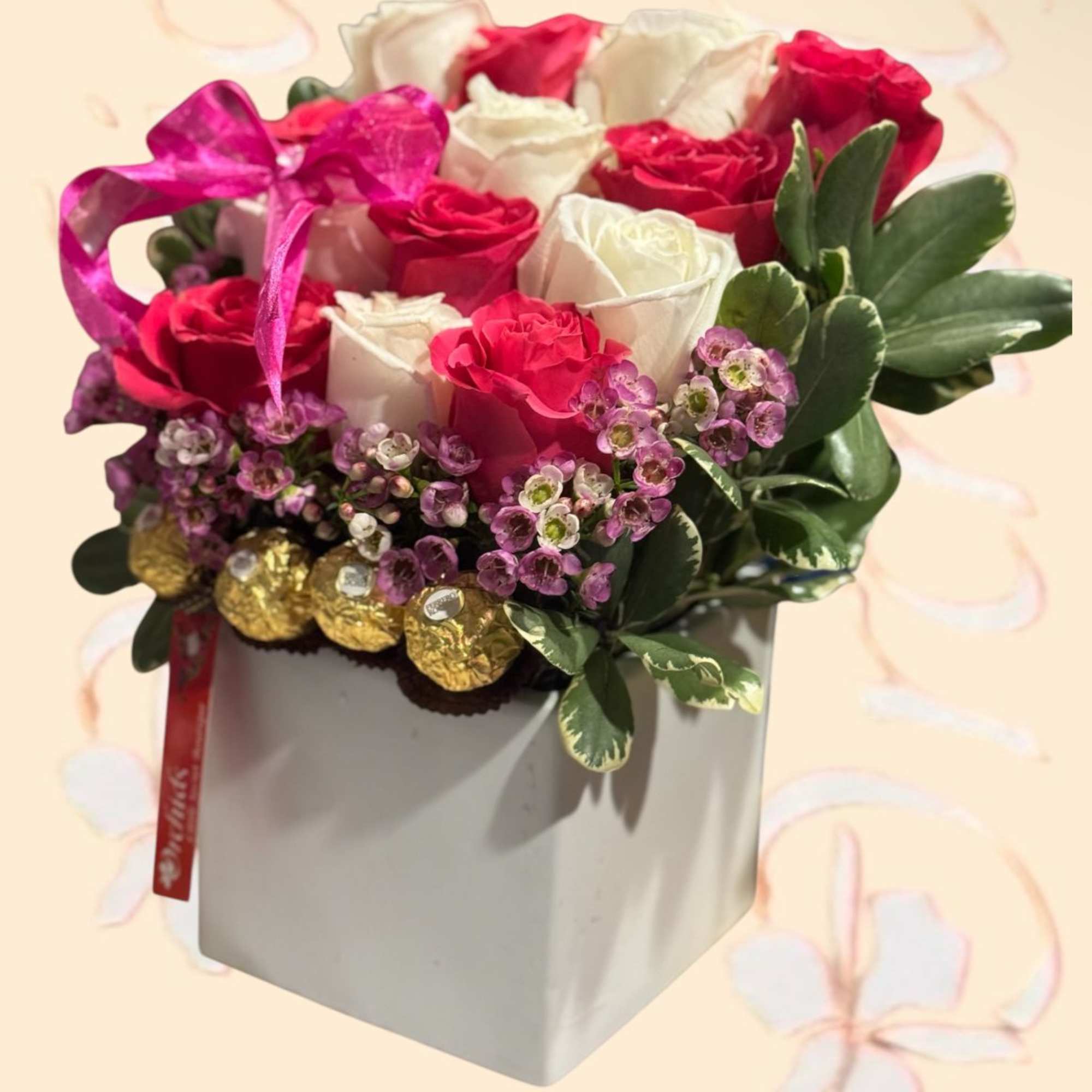 Pink and white roses in a white gift box with chocolates