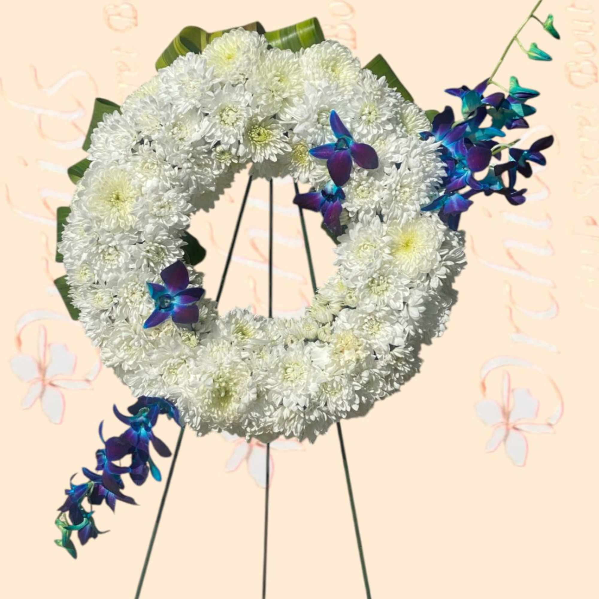 White chrysanthemum wreath with blue-purple orchid accents on a stand