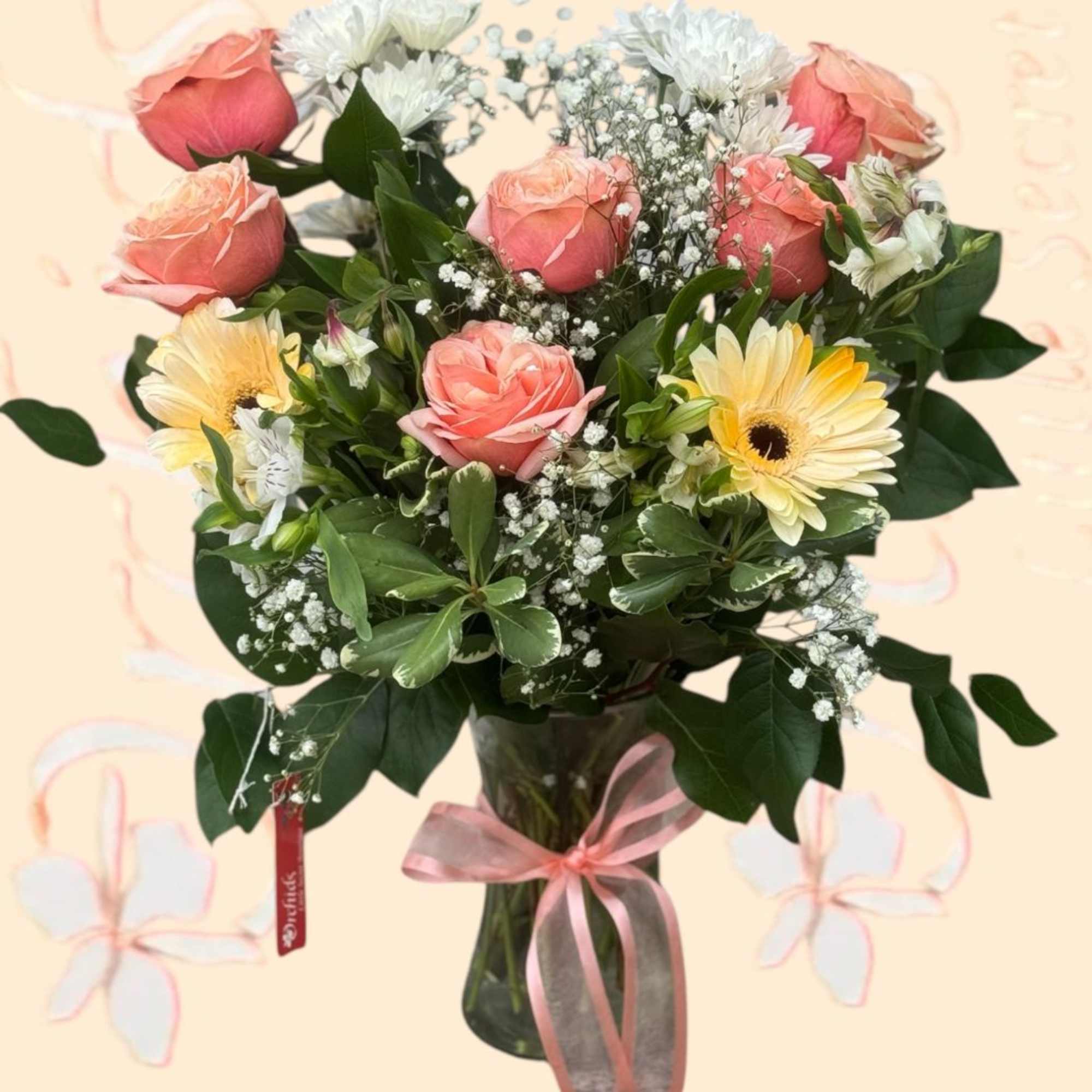 Bouquet of pink roses and pale yellow daisies in a glass vase
