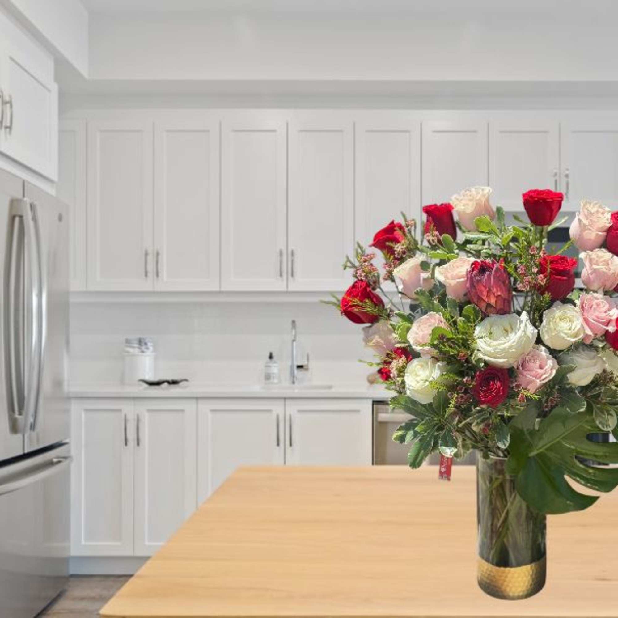 Bouquet of red, pink, and white roses in a glass vase