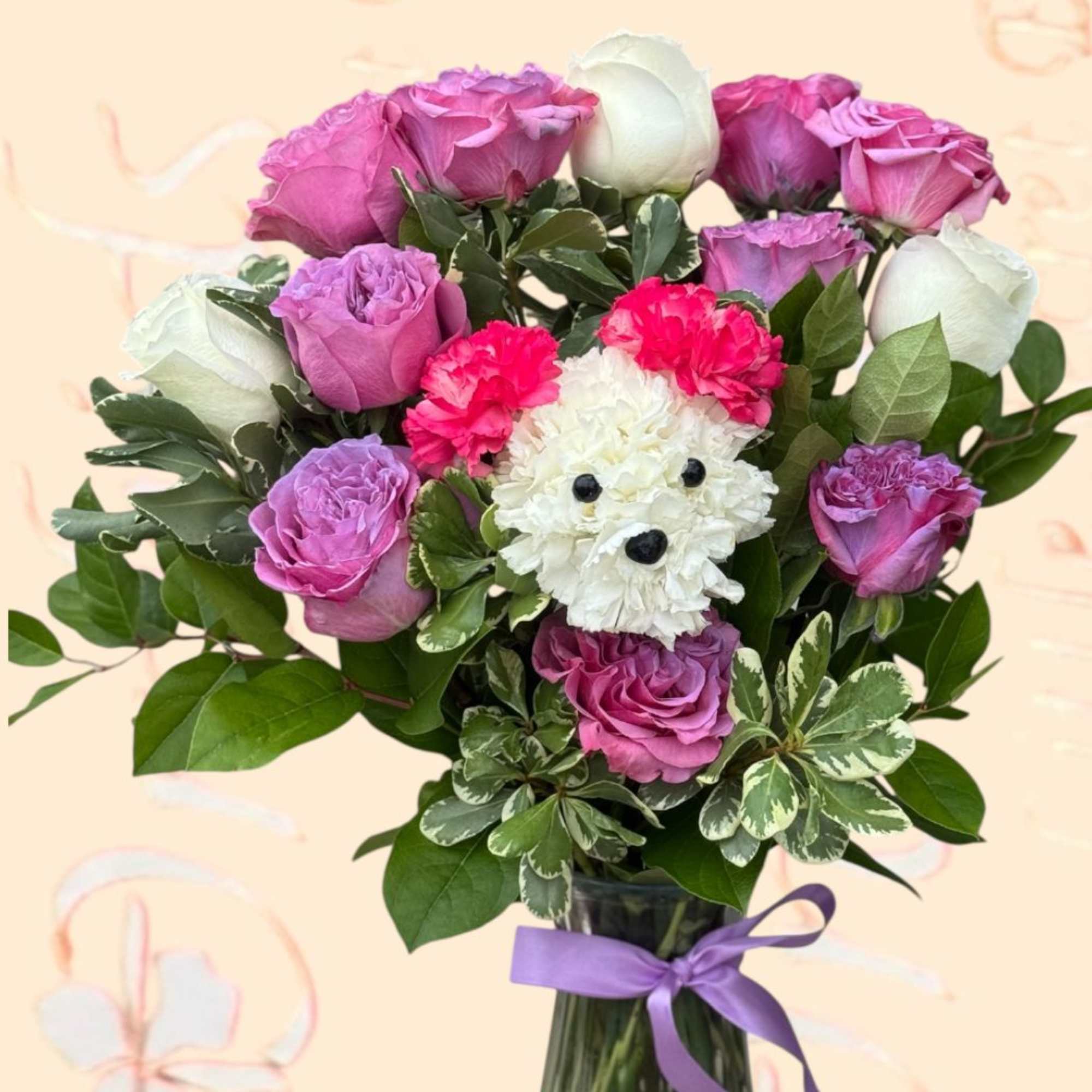 Pink and white rose bouquet with a small white dog-shaped flower accent in a glass vase