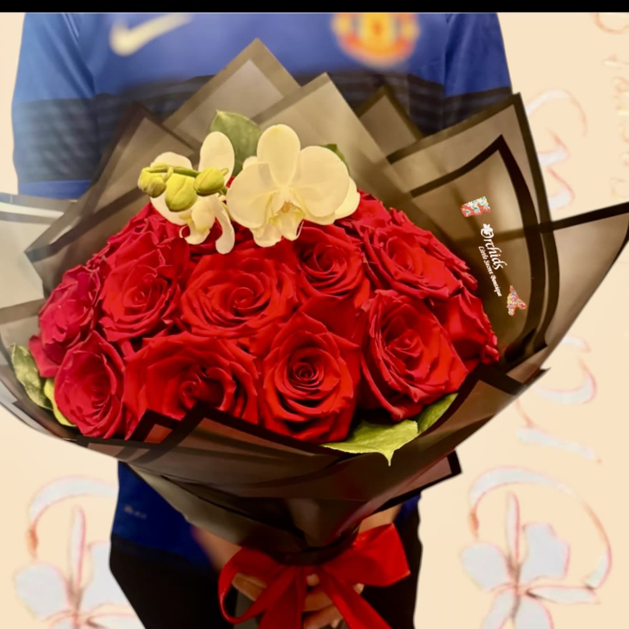 Bouquet of red roses with white orchids wrapped in dark paper, photo 2 of 2