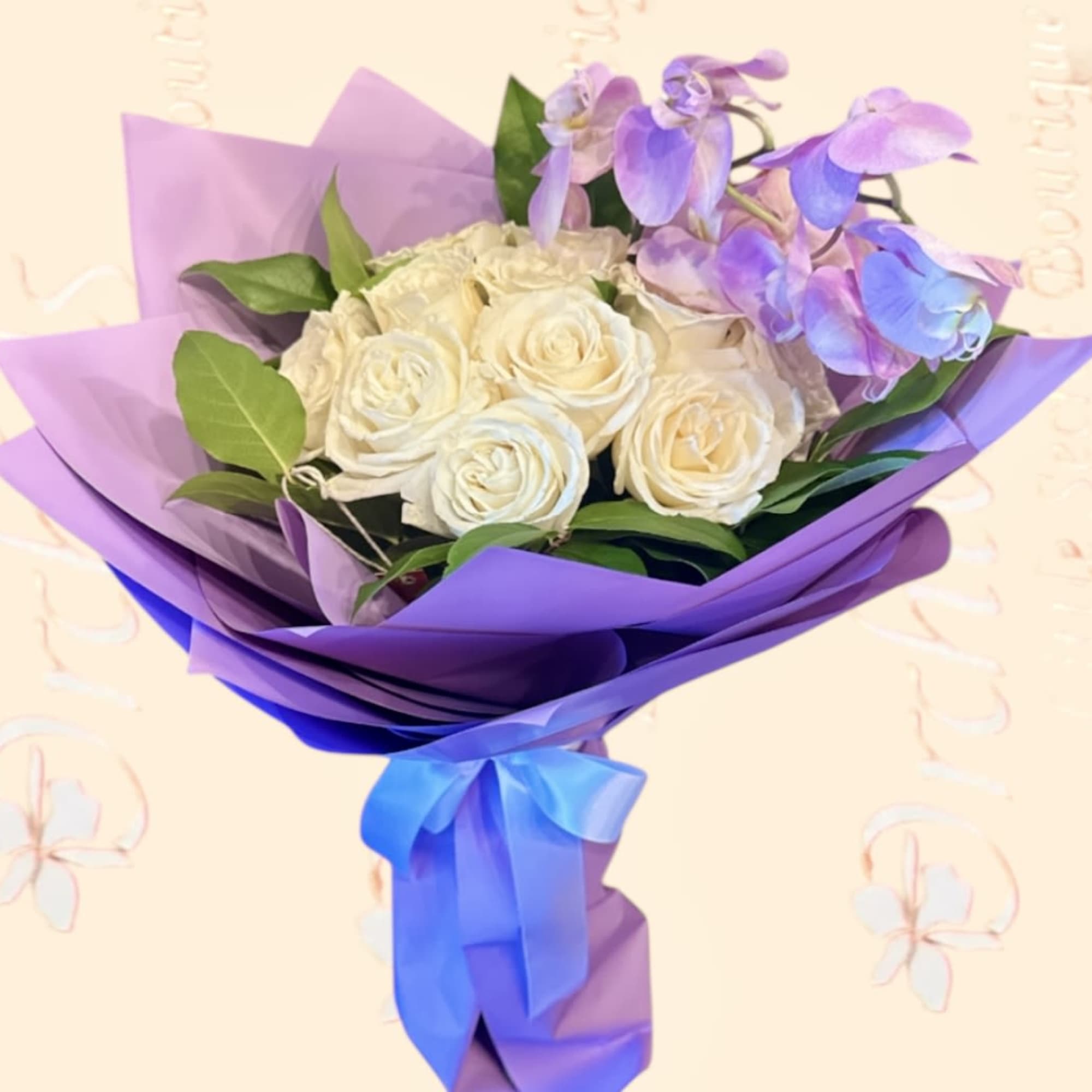Bouquet of white roses and purple orchids wrapped in lavender paper