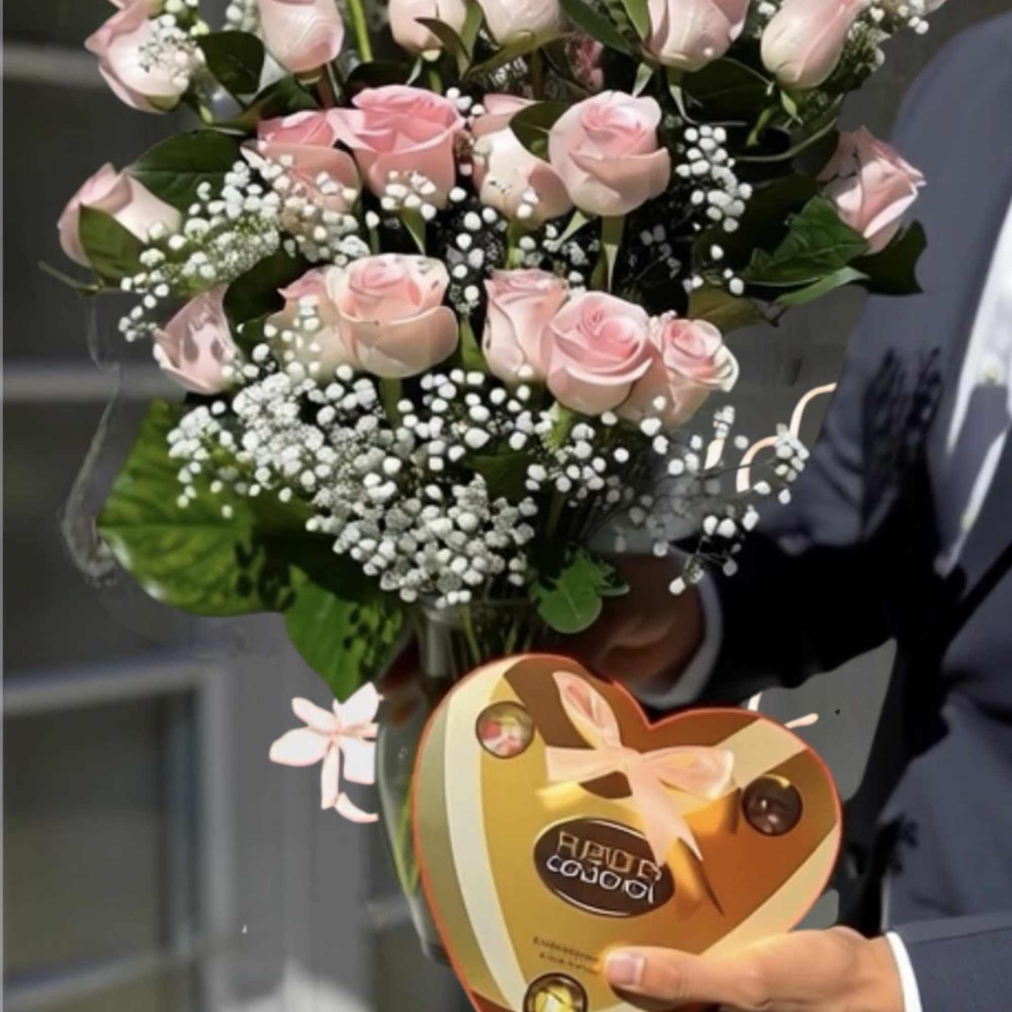 Bouquet of pale pink roses with white baby's breath in a clear wrap