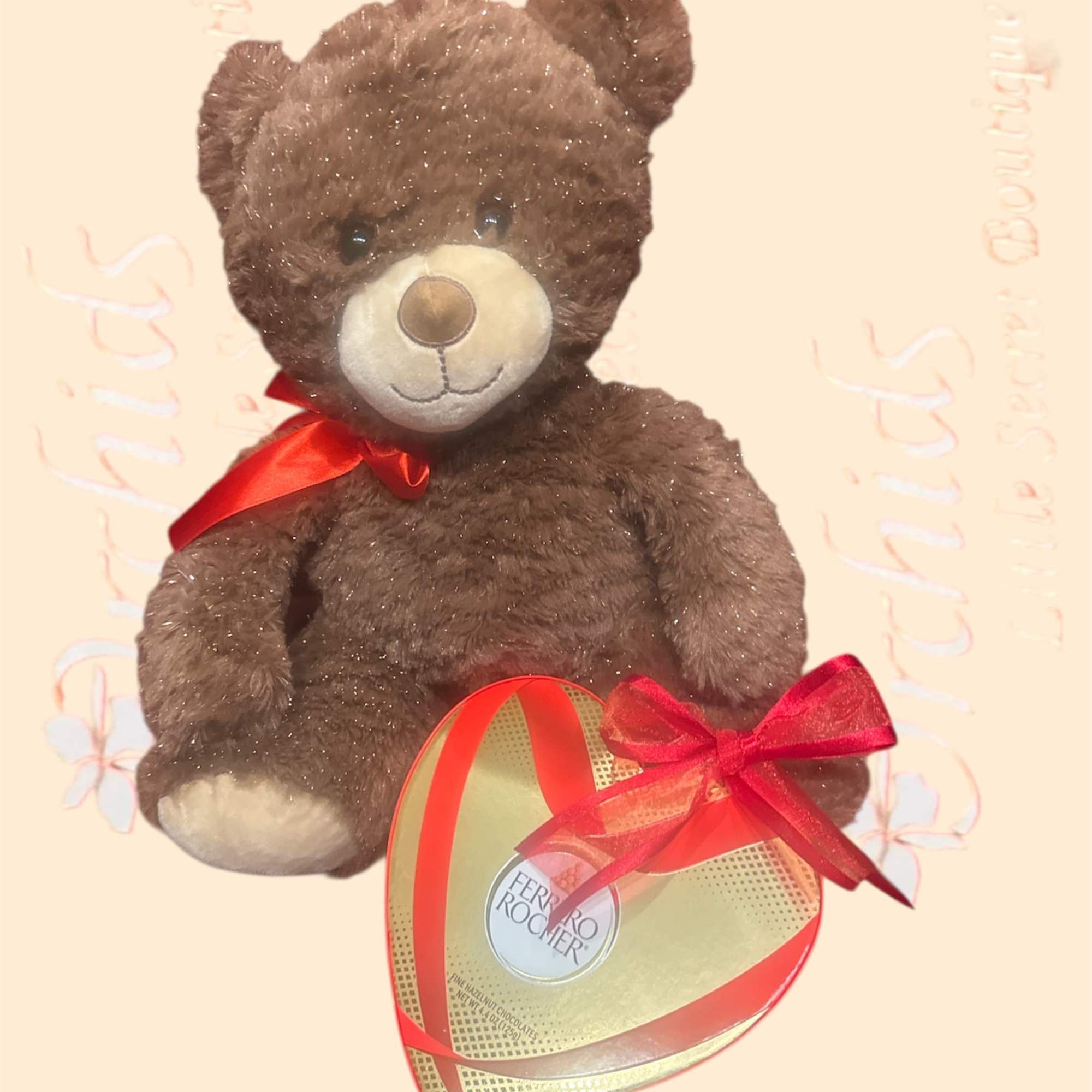 Brown teddy bear with a red bow holding a heart-shaped chocolate box