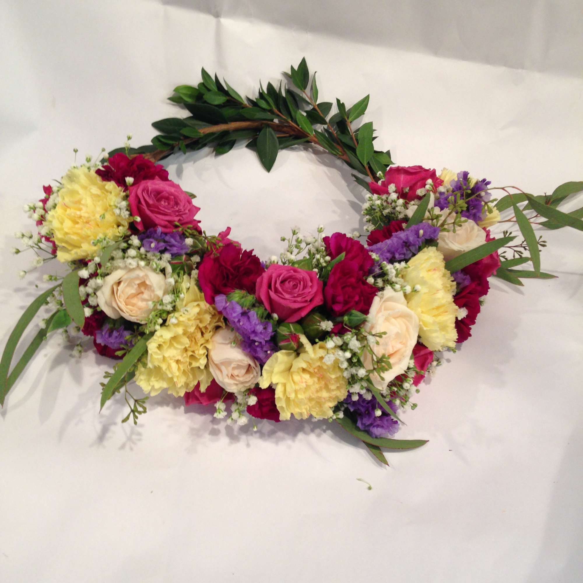 Floral crown with pink, yellow, white, and purple blooms