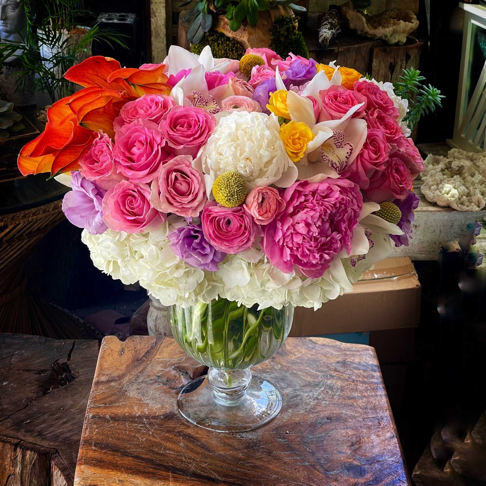 Roses, Hydrangea, Calla, Cymbidium, and more in custom gold color vase.