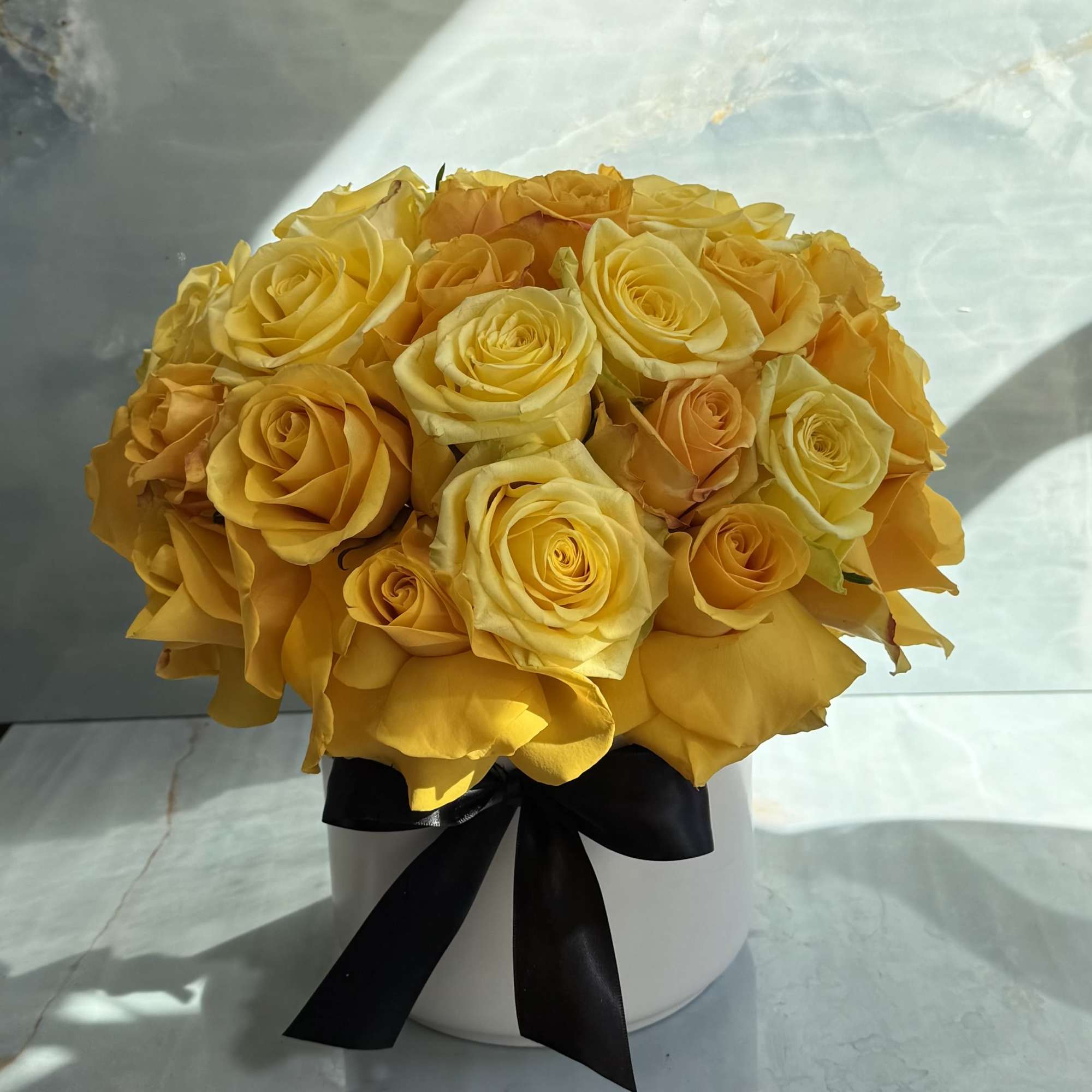 Yellow rose bouquet in a white hatbox with a black ribbon, photo 2 of 2