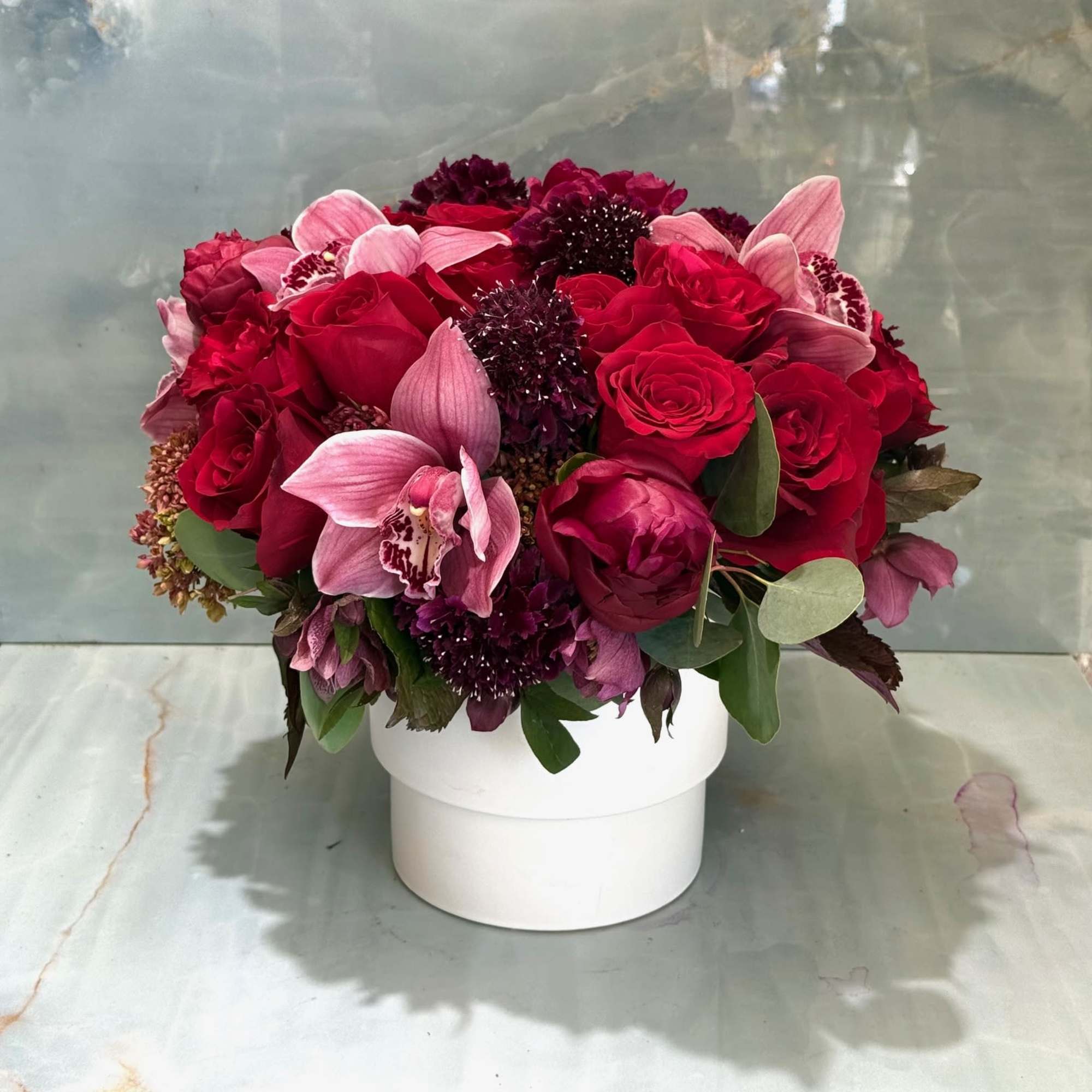 Red and pink rose bouquet in a white box