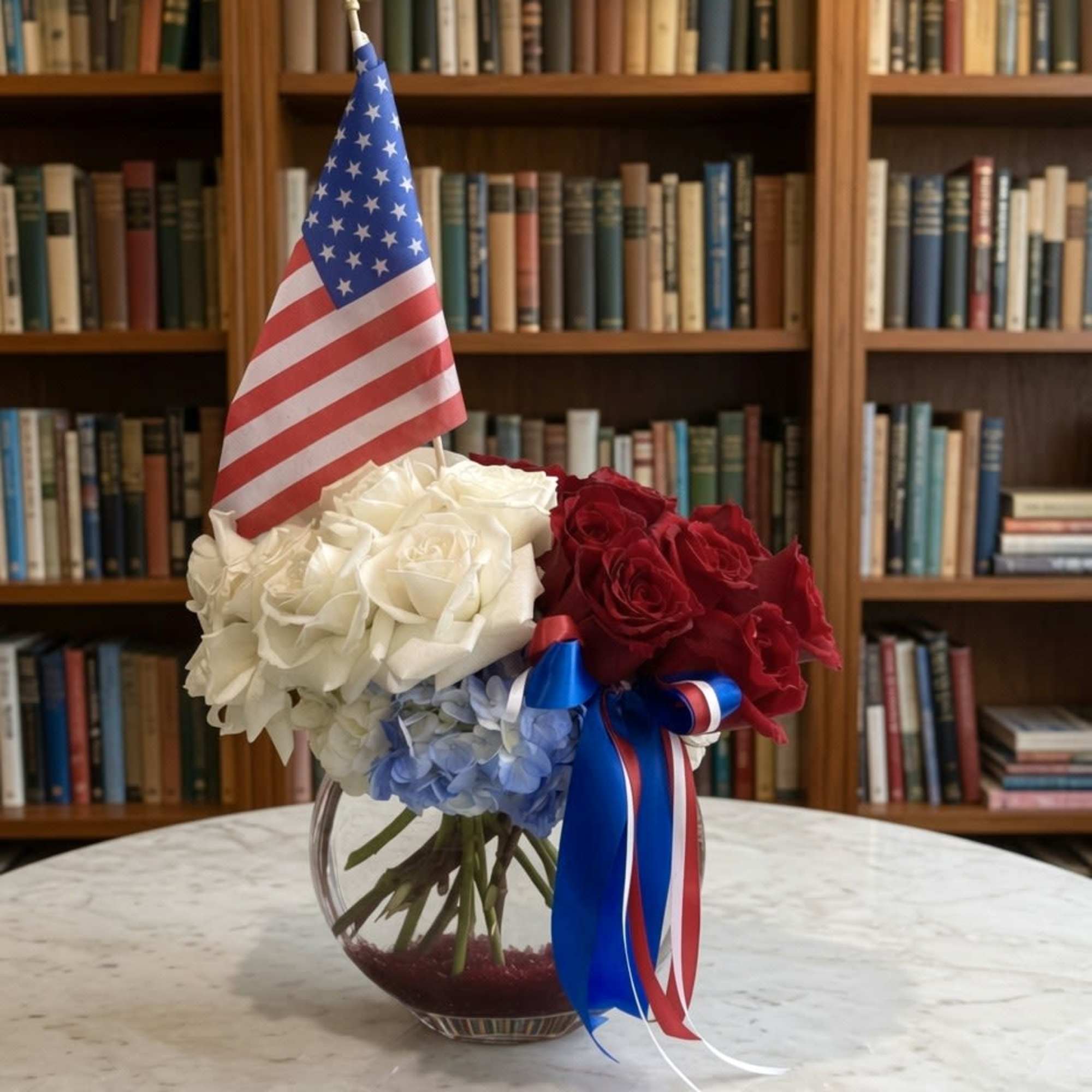 This arrangement is a graceful tribute to timeless American elegance. Rich red