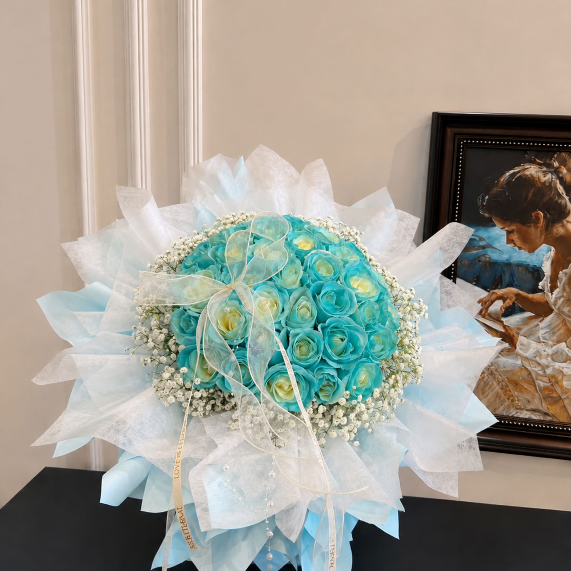 Round bouquet of turquoise and pale yellow roses wrapped in white and blue paper