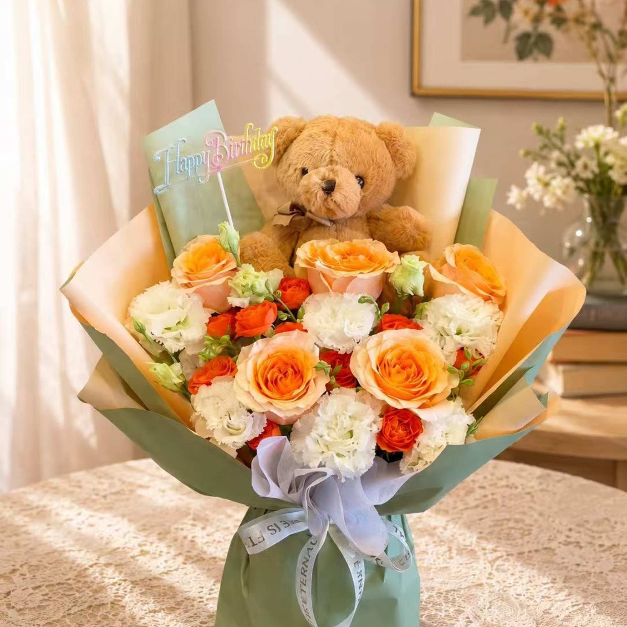 Bouquet of orange and white roses with a teddy bear and Happy Birthday topper