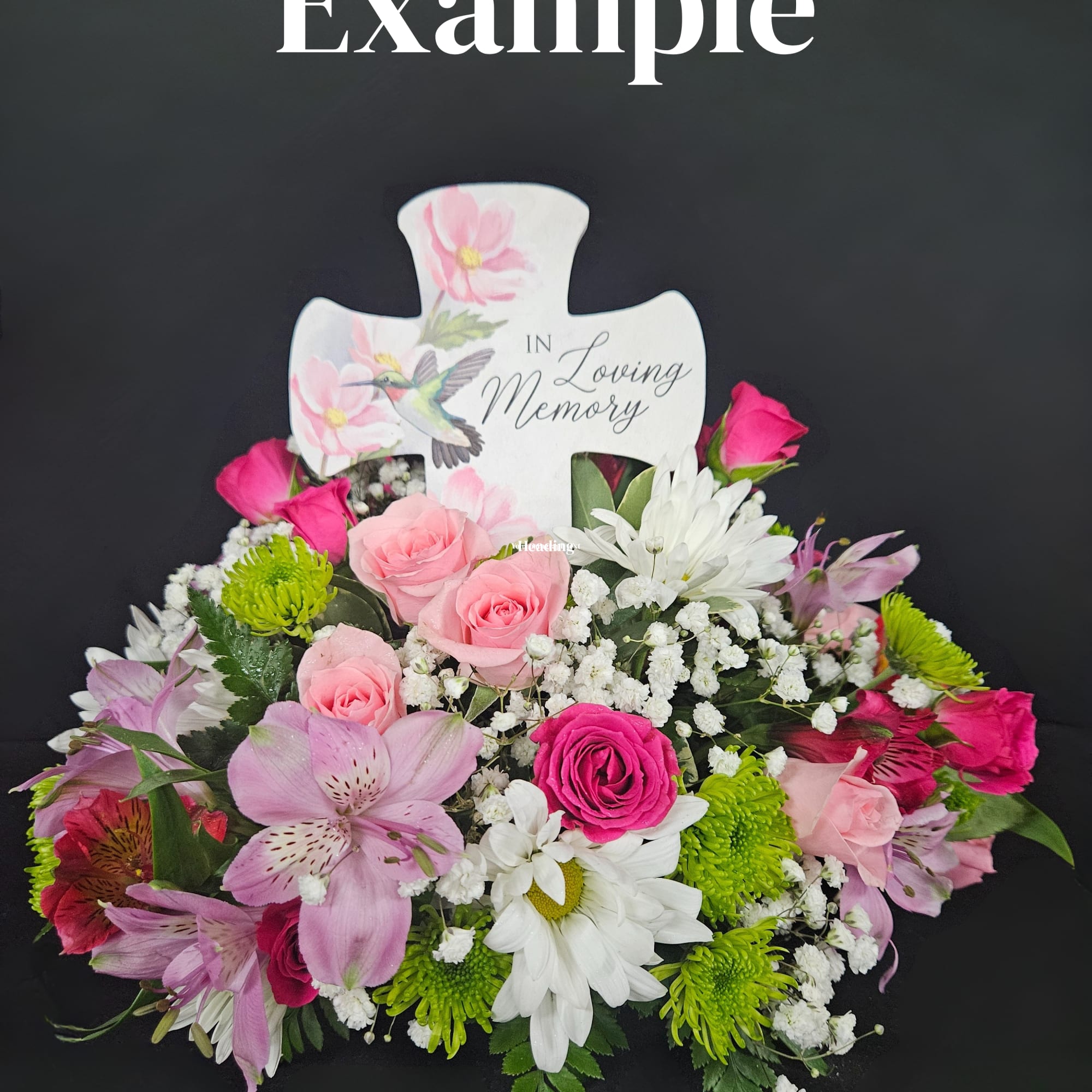Pink and white sympathy floral arrangement with a memorial cross
