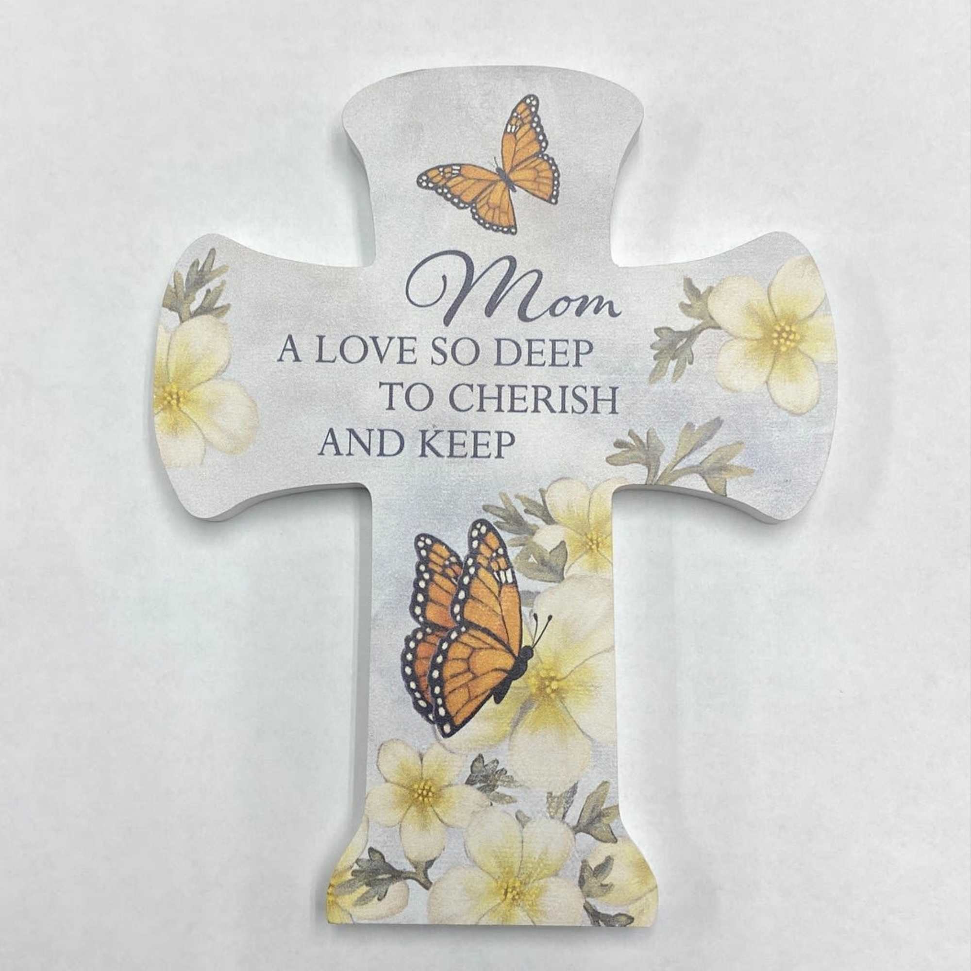 Cross-shaped memorial plaque with butterflies and flowers reading "Mom"