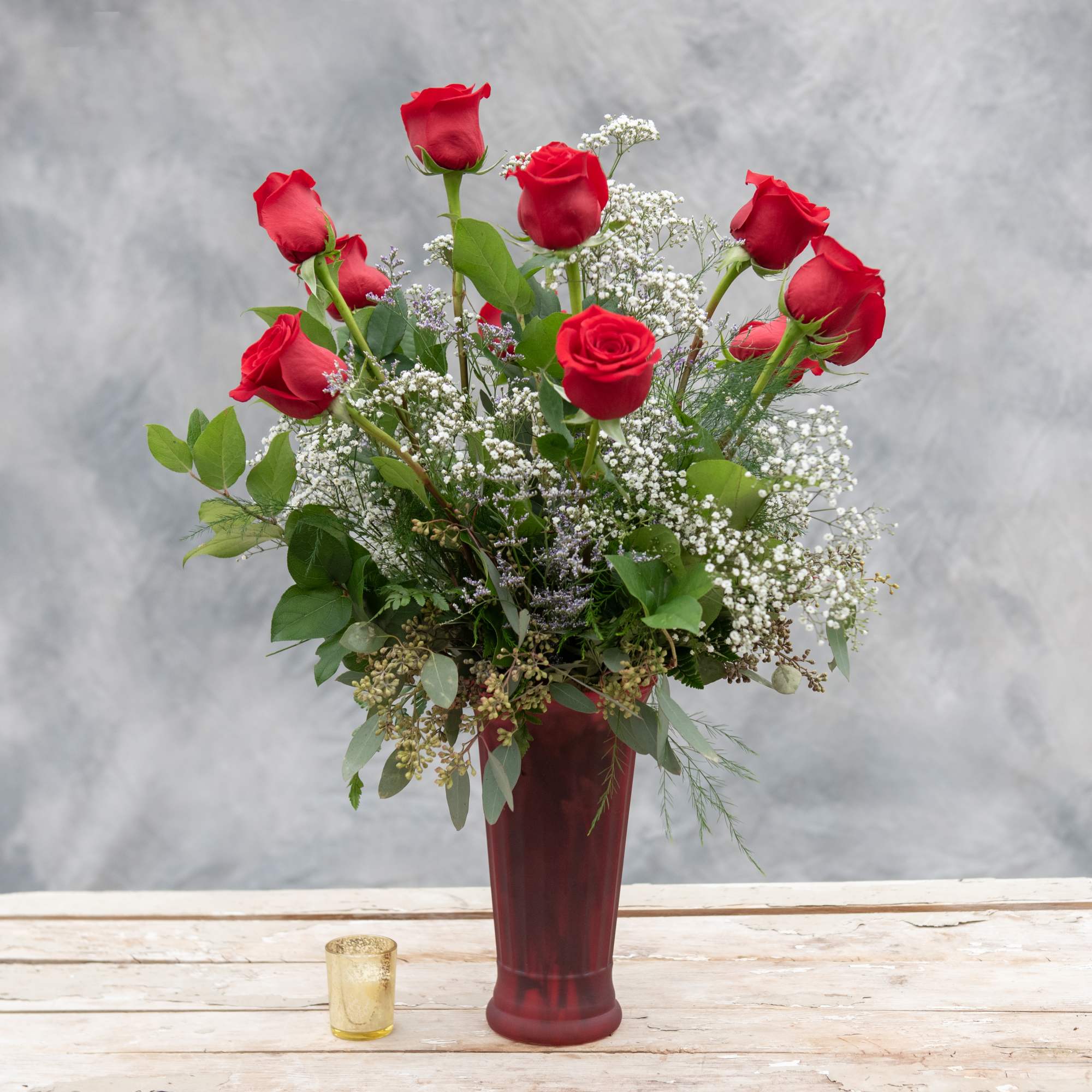 One dozen long stemmed red roses arranged in our ruby rose vase