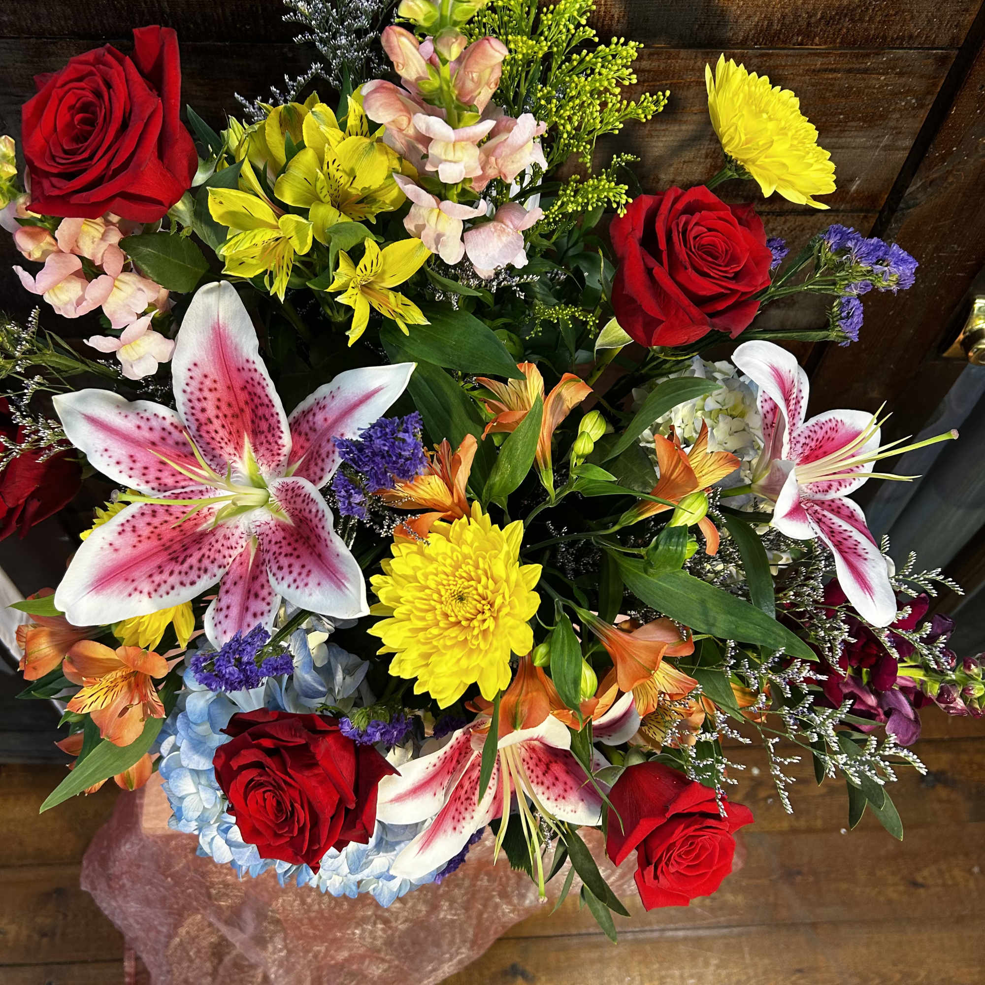 Mixed bouquet with red roses, lilies, and yellow chrysanthemums