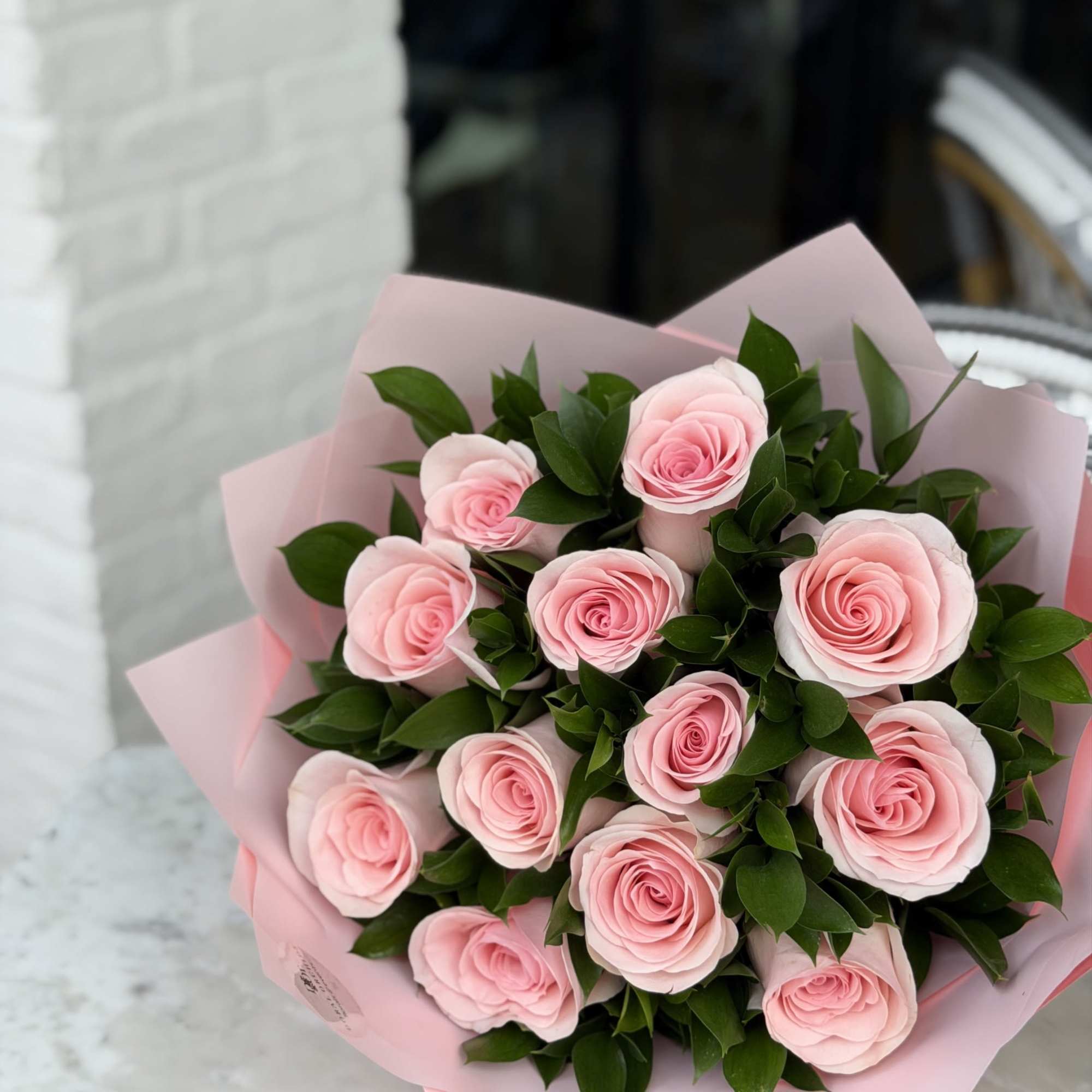 A romantic and elegant arrangement featuring a dozen soft pink roses paired, photo 4 of 4