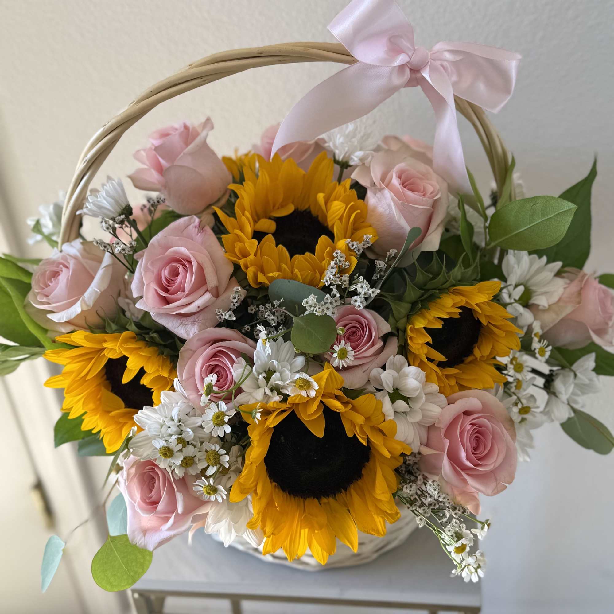 Basket arrangement of pink roses and sunflowers with a pink ribbon, photo 2 of 3