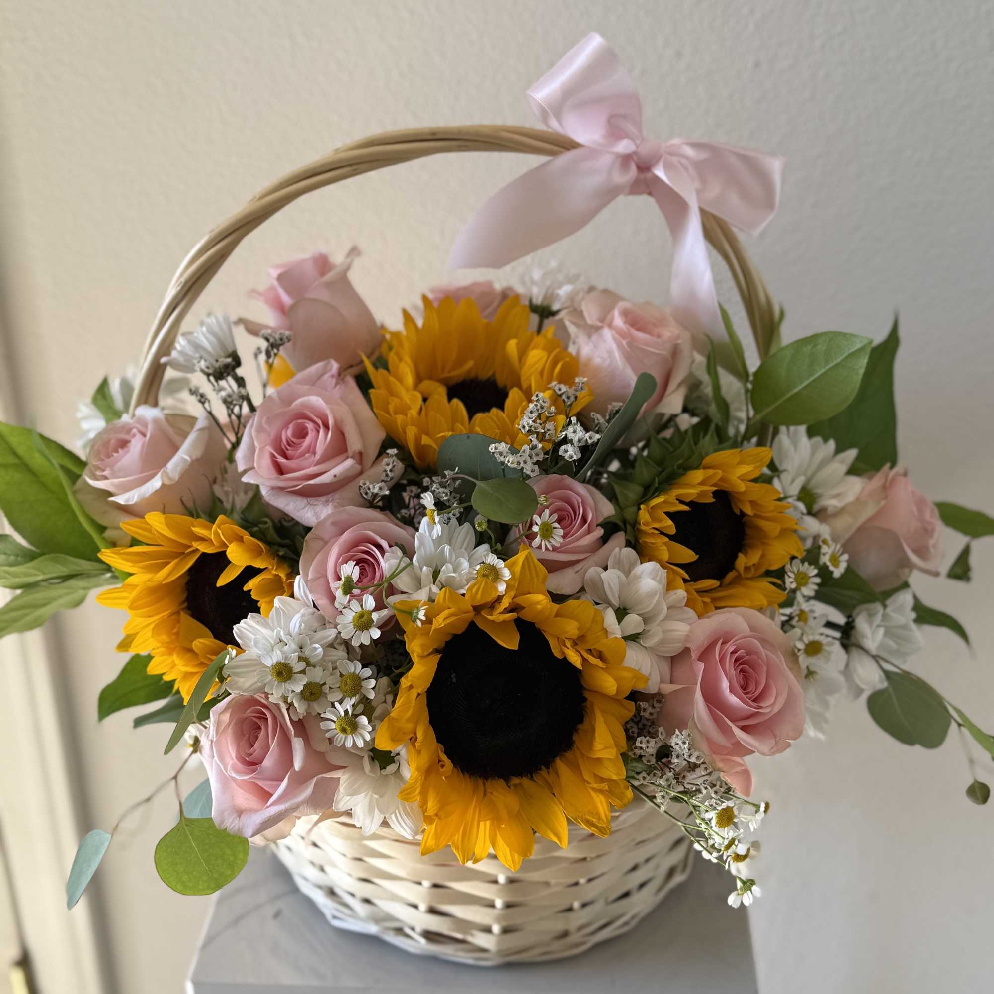 Basket arrangement of pink roses and sunflowers with a pink ribbon, photo 3 of 3