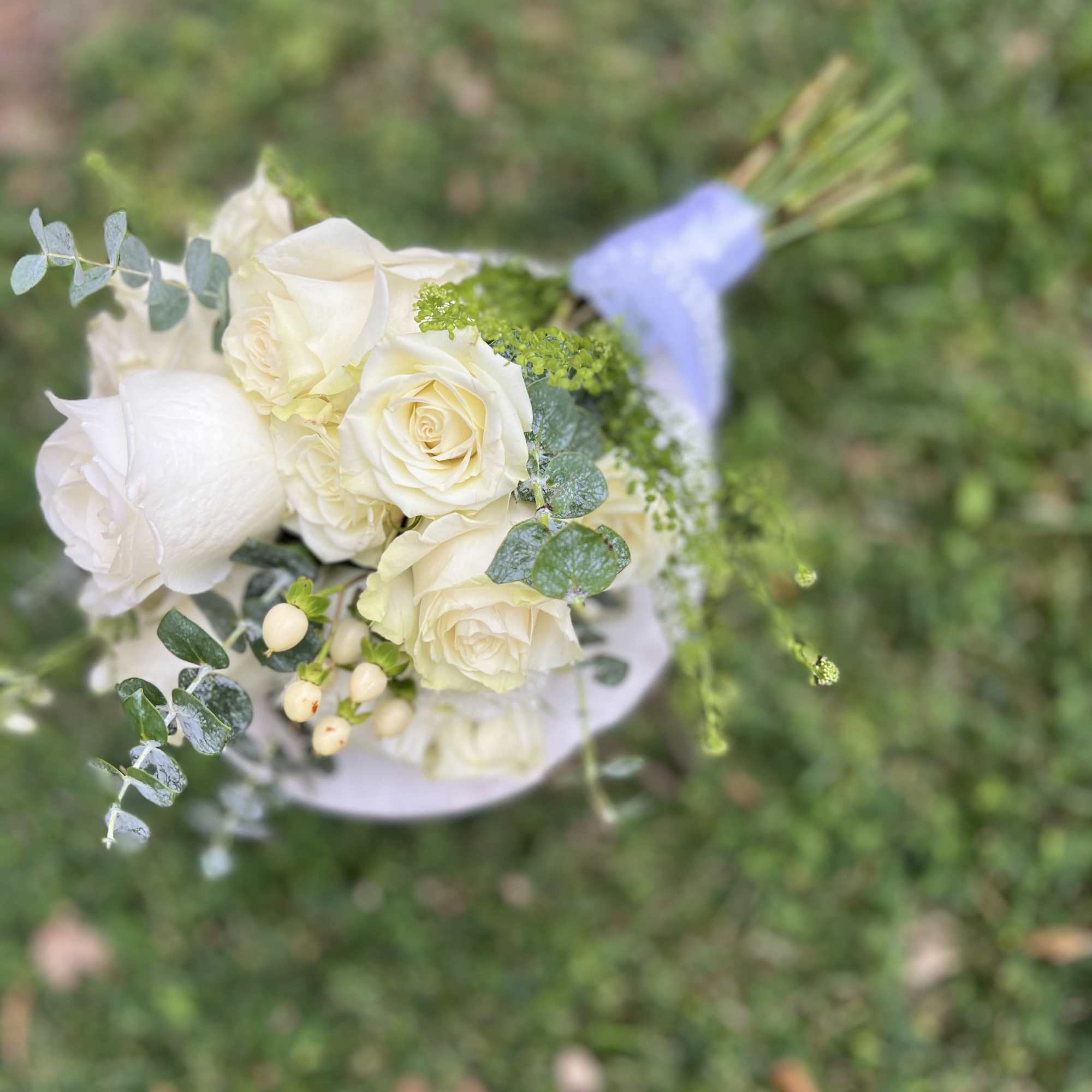 White rose bouquet with eucalyptus and small berries