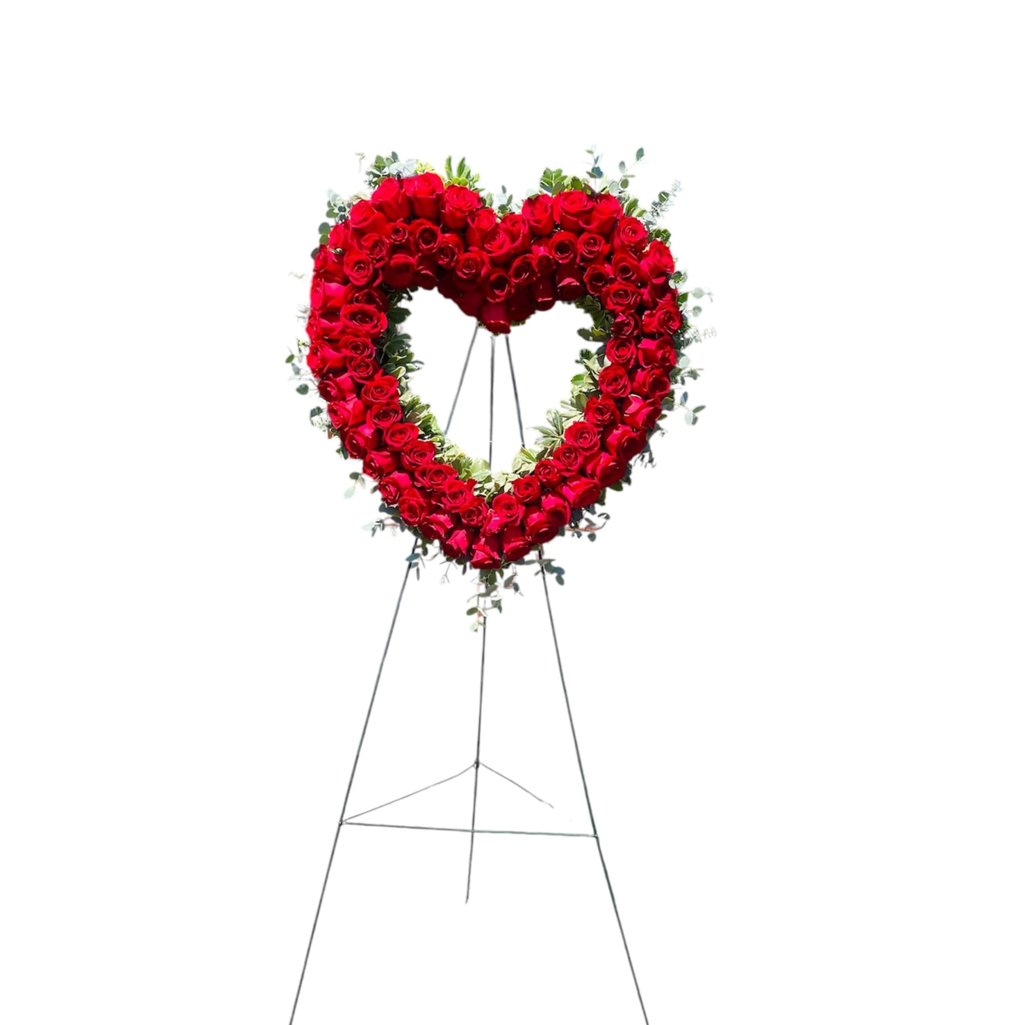 Heart-shaped standing wreath of red roses on an easel
