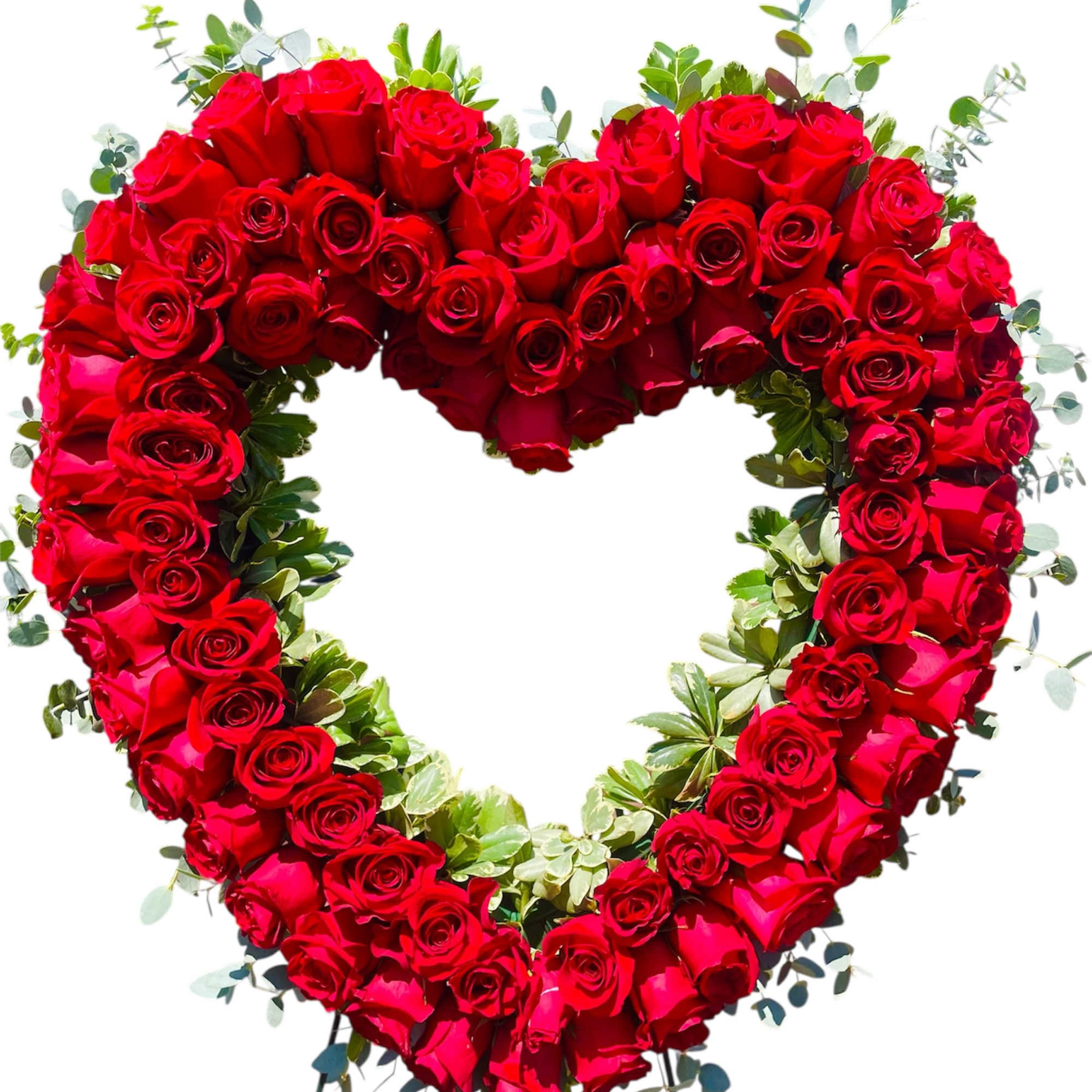 Heart-shaped red rose arrangement with greenery on a stand