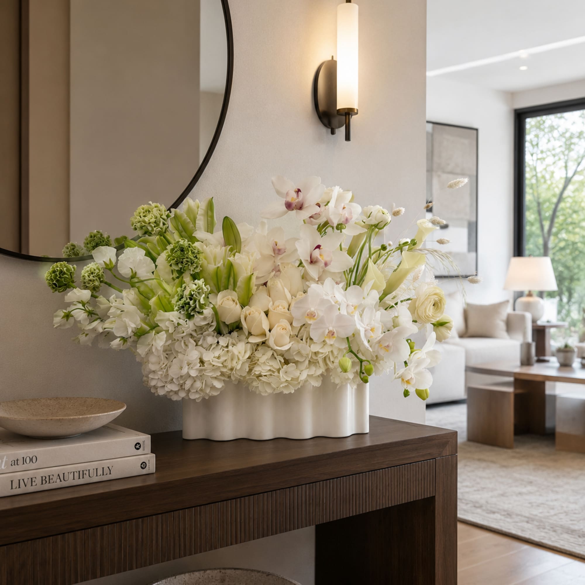 White floral arrangement in a white vase on a console table